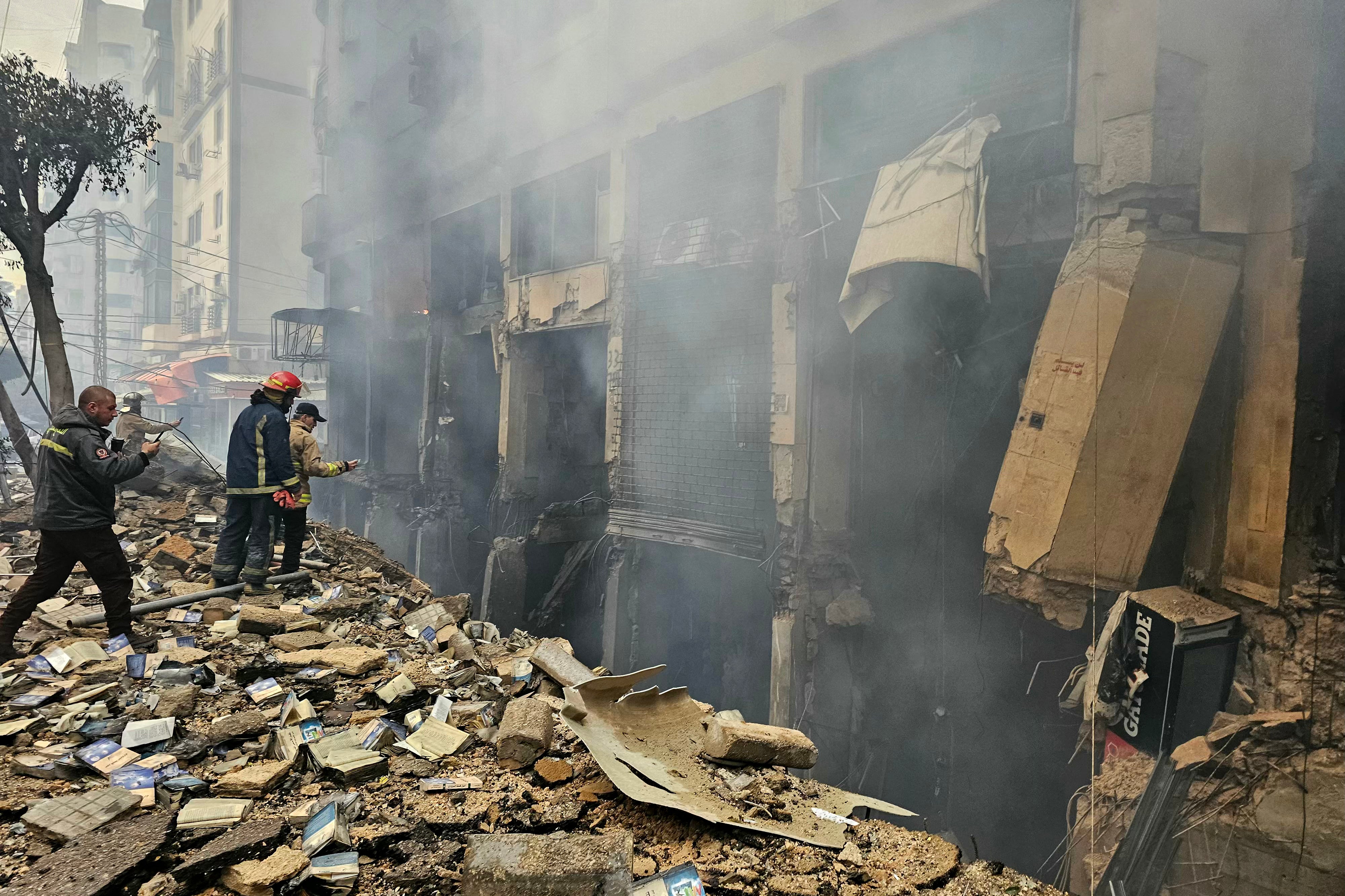 Rescuers are seen at the site of an Israeli airstrike in Beirut's southern suburb Haret Hreik on March 15, 2026.