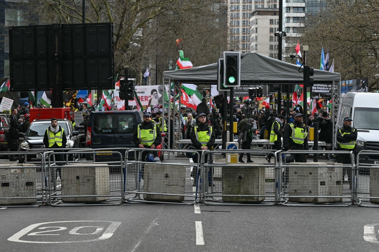 Police block off access to protesters (behind) taking part in an annual protest