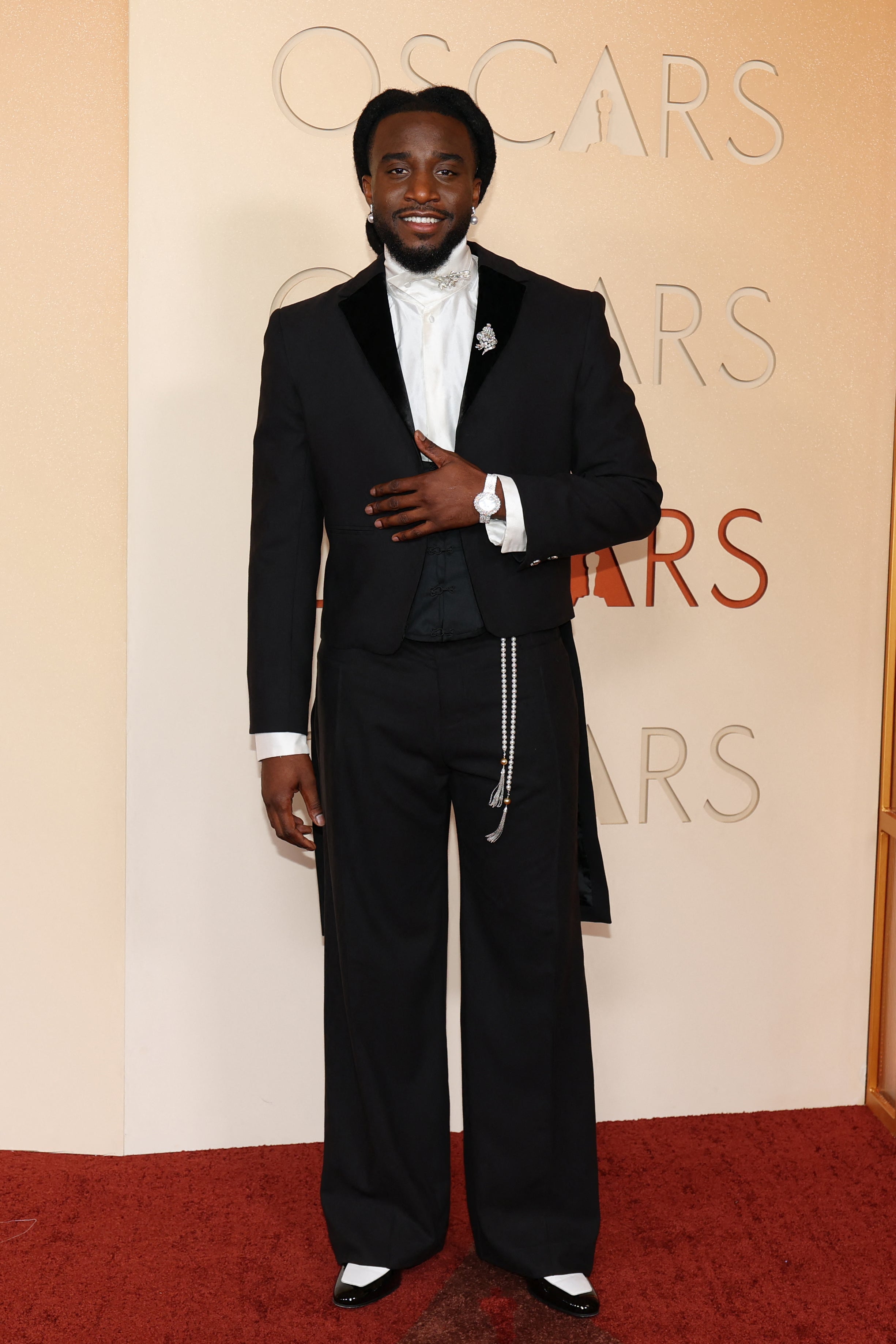 ‘A Bar Song (Tipsy)’ singer Shaboozey looked slick in a sharply tailored black tuxedo, complete with pearl details and a jeweled brooch.