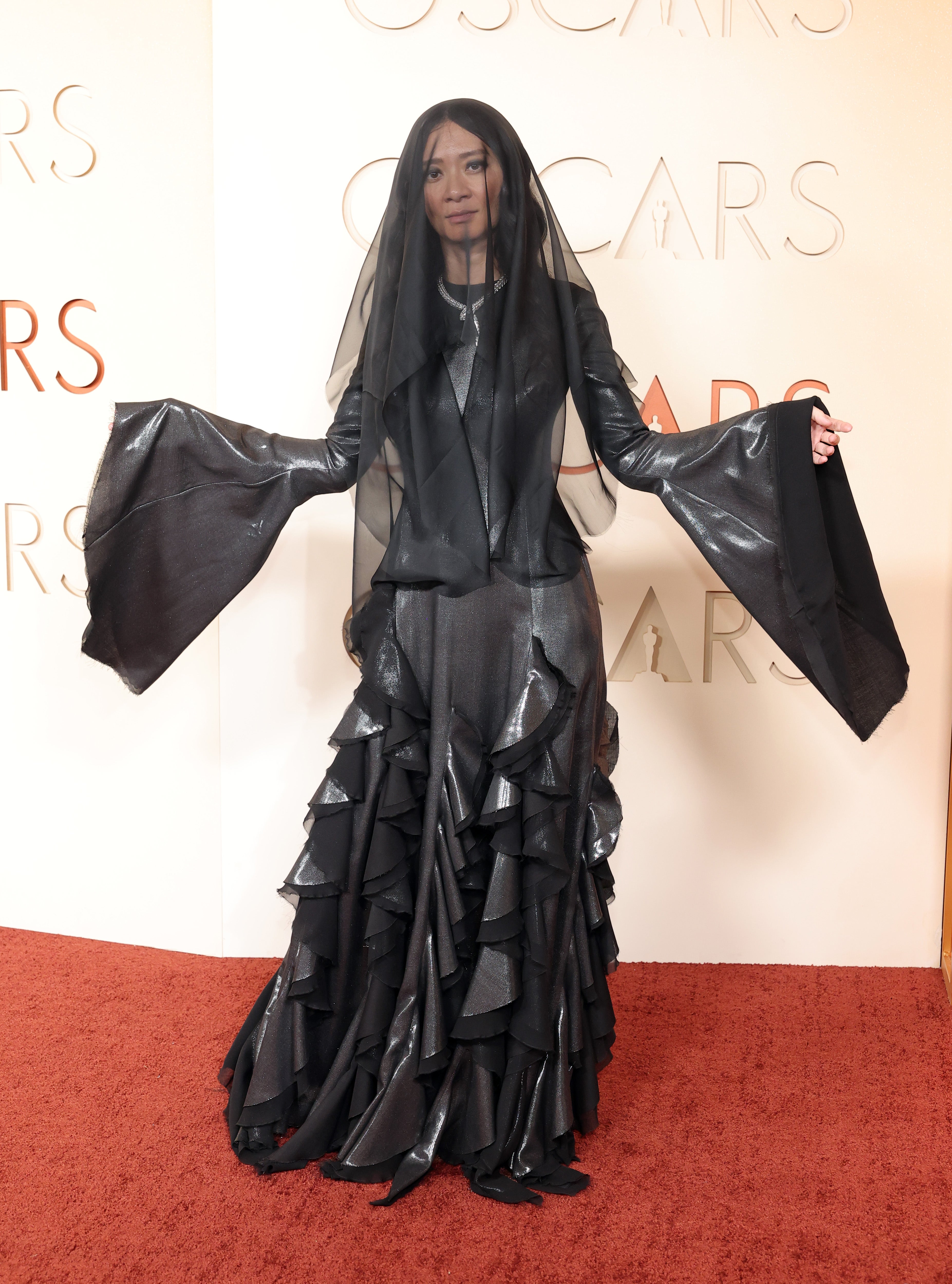 The ‘Hamnet’ director seemed better suited to be in the Addams Family, as she wore a black Gabriela Hearst gown with draping sleeves and an eerie black veil
