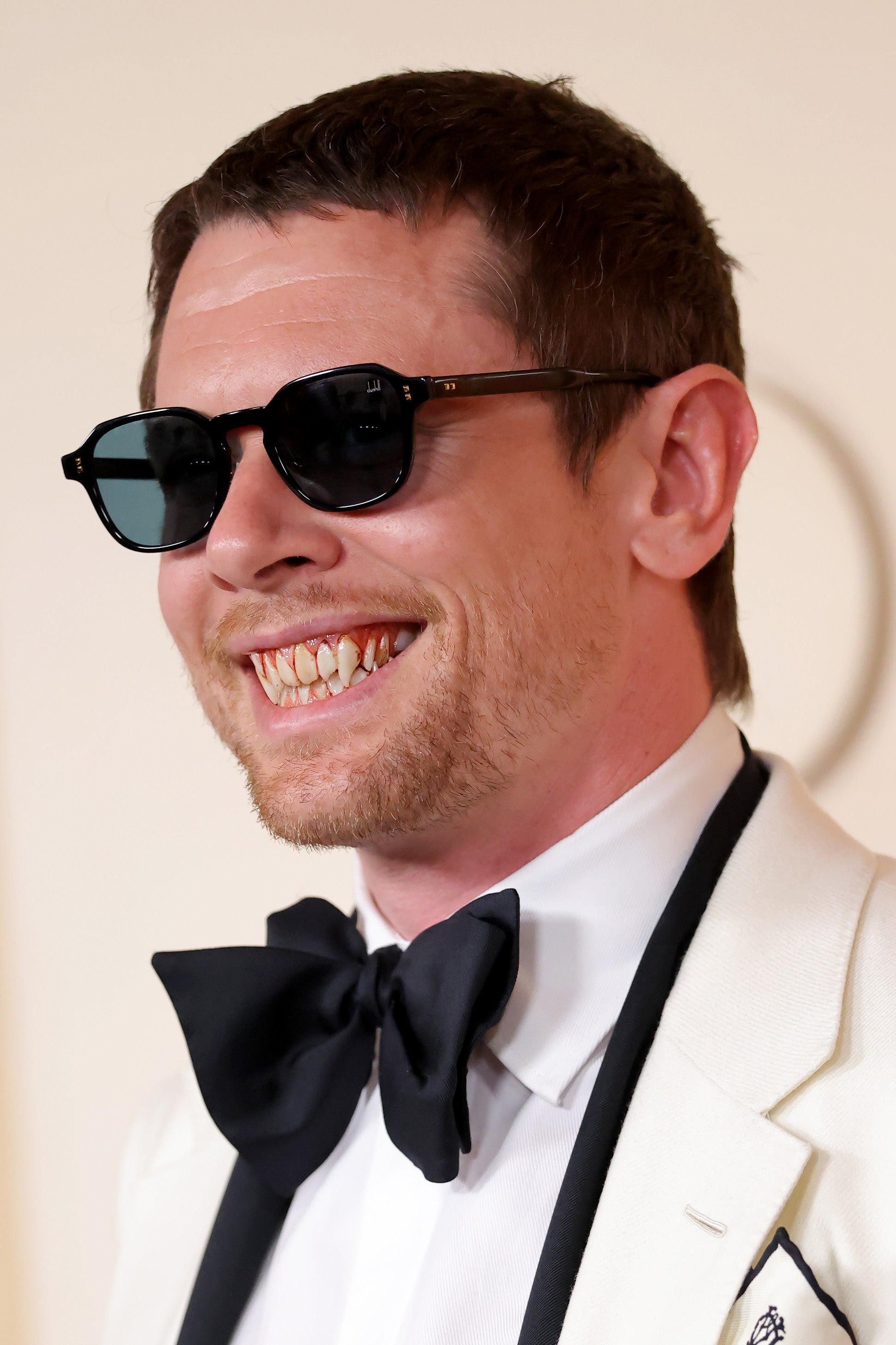 The ‘Sinners’ actor continued his vampire role on the red carpet as he wore a set of bloody fangs