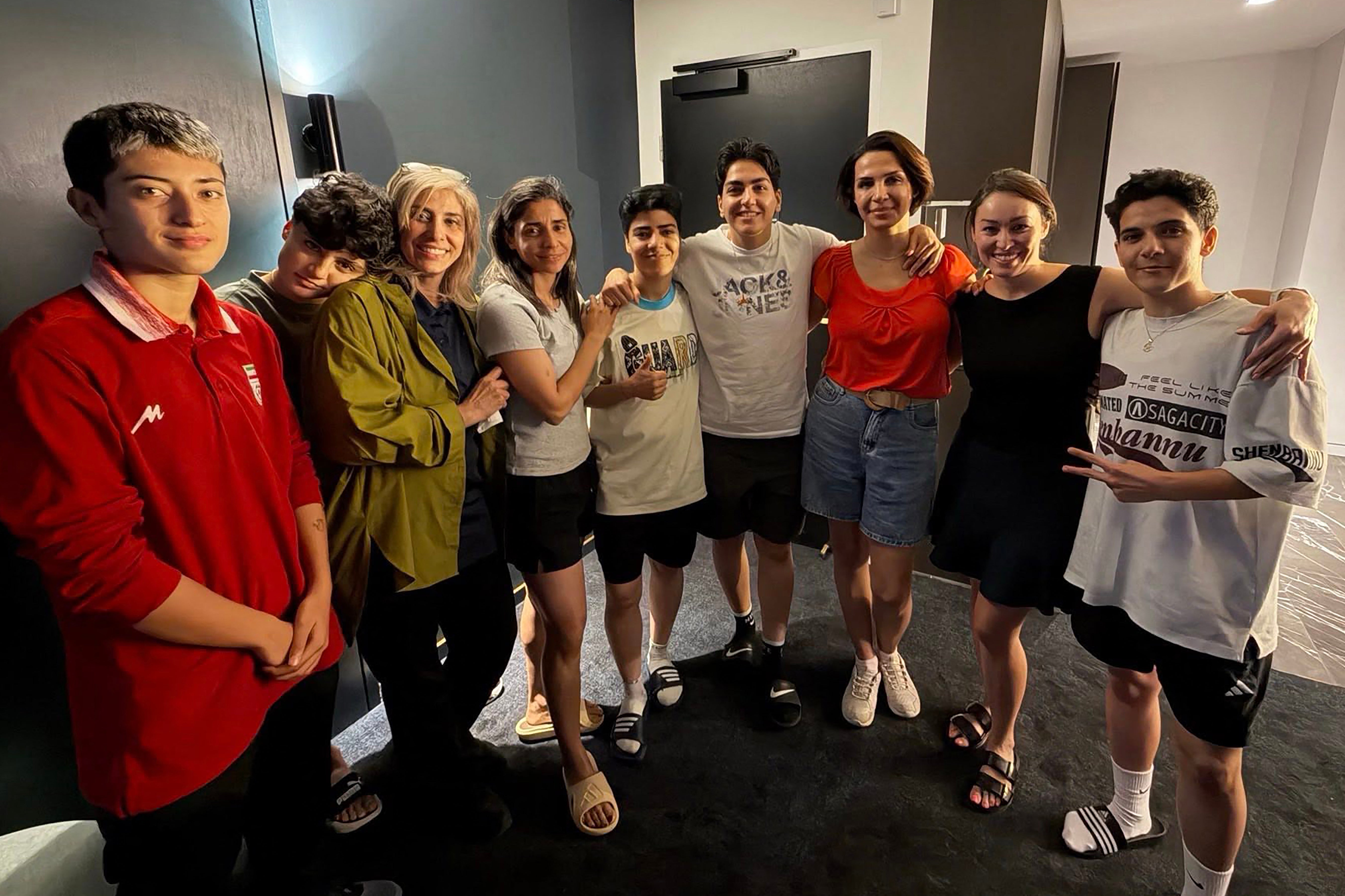 An undated photo released by Australia's Department of Home Affairs on March 11, 2026 shows six Iranian football players and a team official with two unidentified local officials (2nd and 3rd R) in Sydney, after they claimed asylum in Australia.