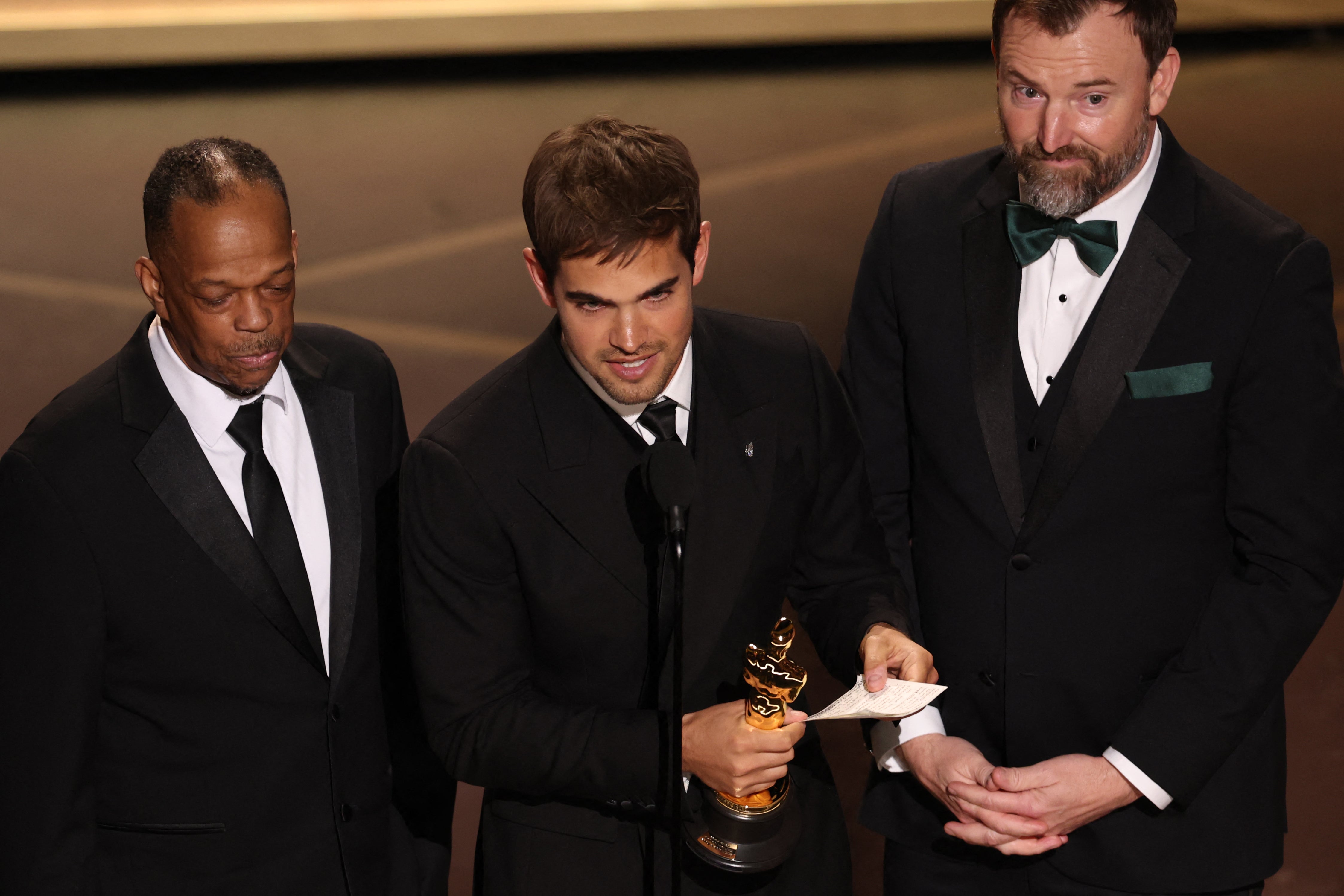 Filmmakers Sam Davis (middle) and Jack Piatt (right) accepeted the award for Best Live Action Short Film for 'The Singers'