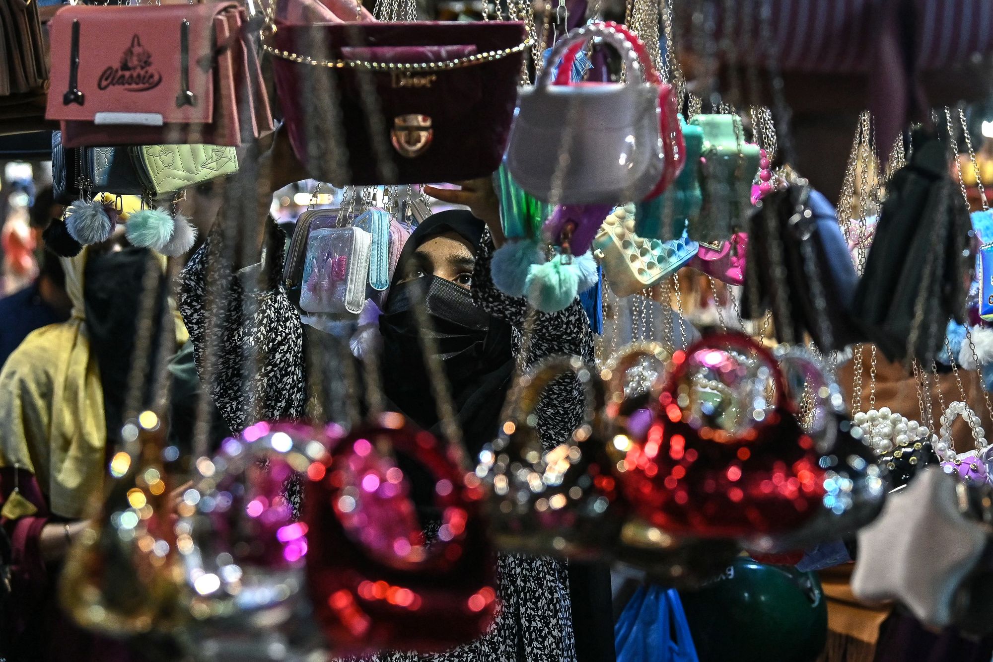 A Muslim woman shops for the Eid al-Fitr celebrations during the last week of the Islamic holy fasting month of Ramadan in Karachi.