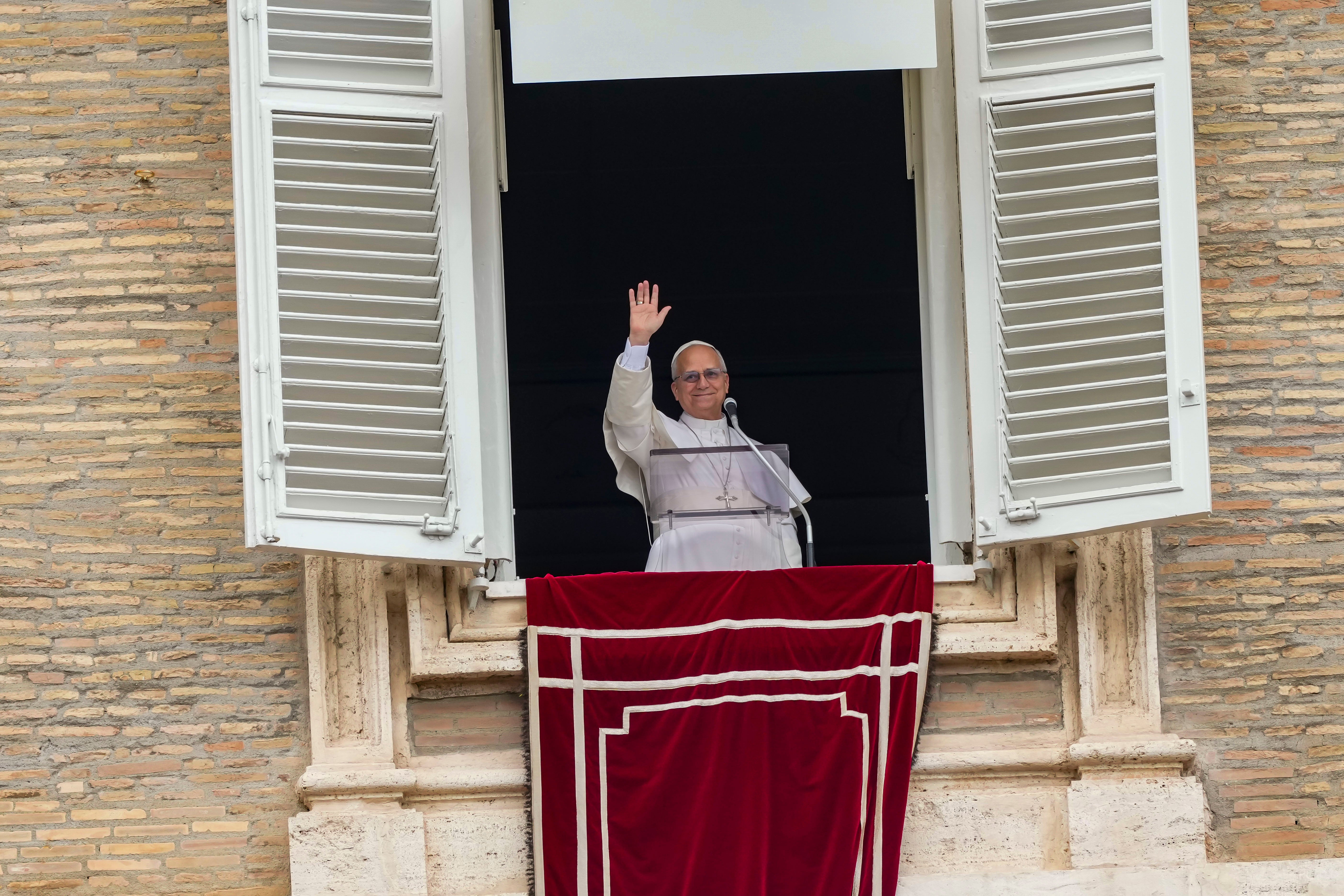 Pope Leo XIV appears at the window of his studio overlooking St. Peter's Square at the Vatican.