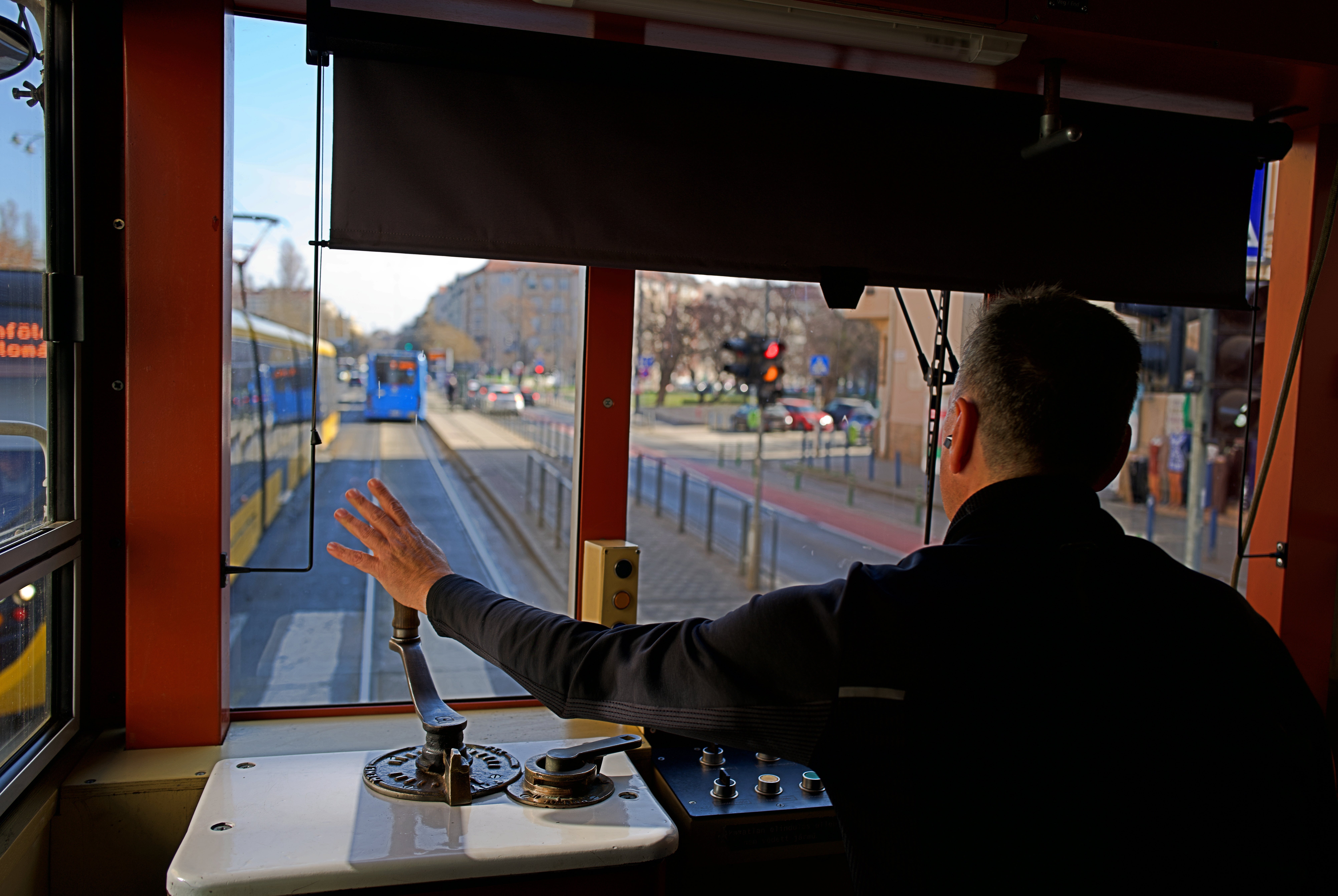 A driver waves while operating a century-old freight tram in Budapest