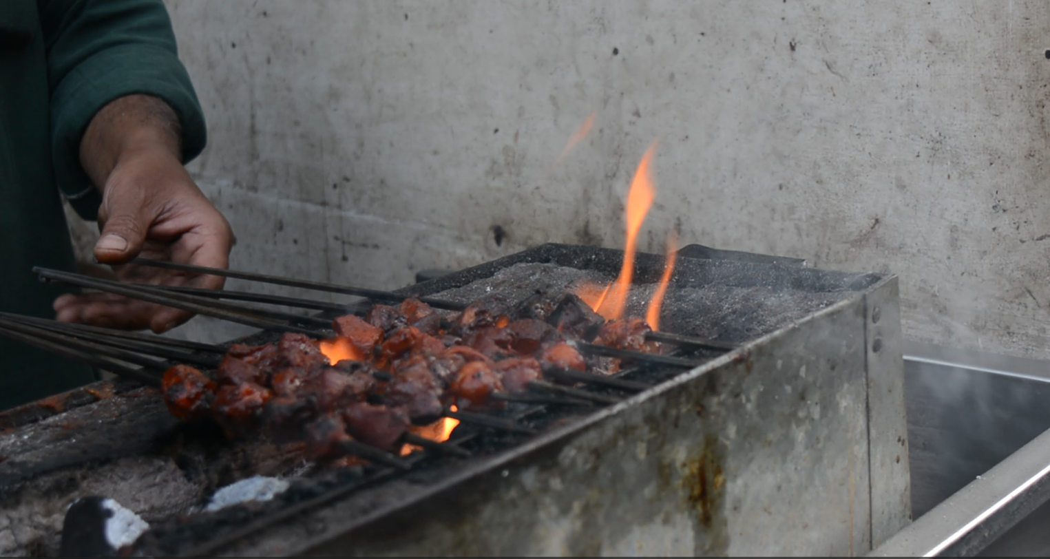 Mohammad Mutaqeen cooks kebabs on coal in Old Delhi