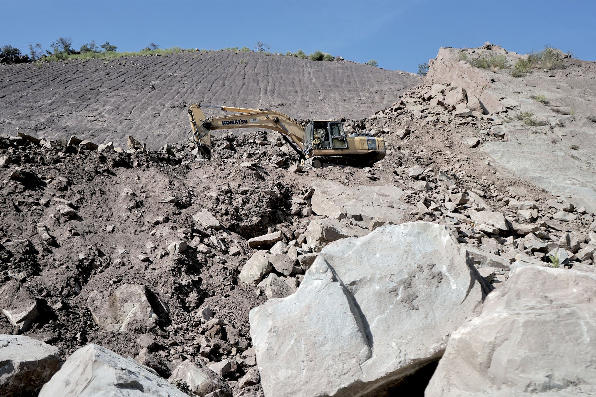 A bulldozer clearing landslide debris on National Highway 44
