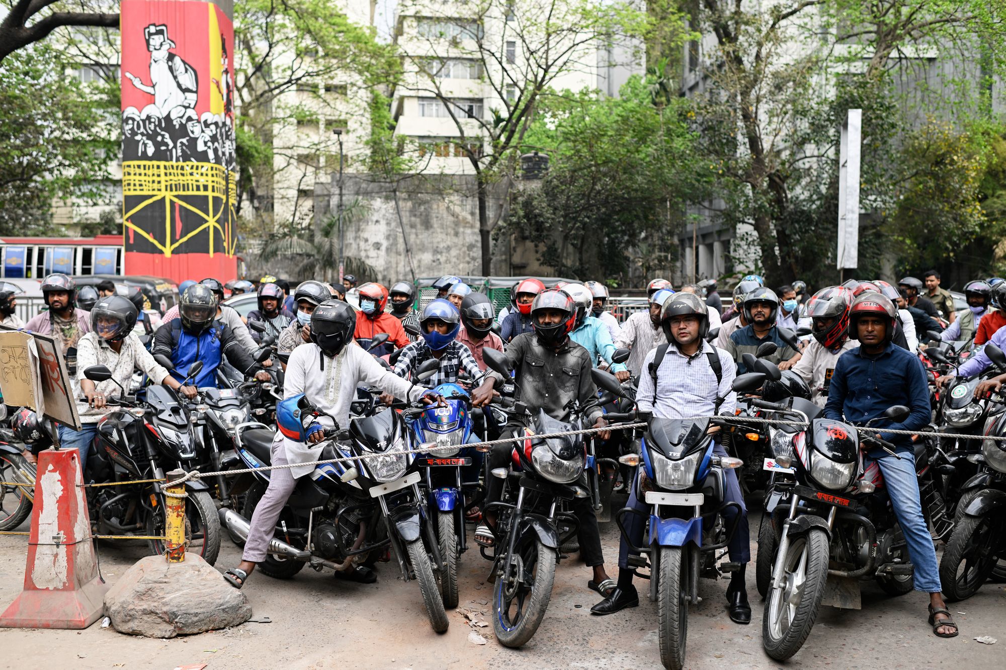 FILE - Motorists wait behind a rope for their turn to get fuel at a pump, fearing a possible fuel shortage due to the Iran war, in Dhaka, Bangladesh, Sunday, March 8, 2026