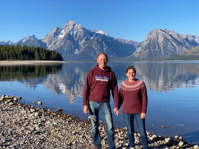 Richard and Jackie Pickles in front of a lake and mountains