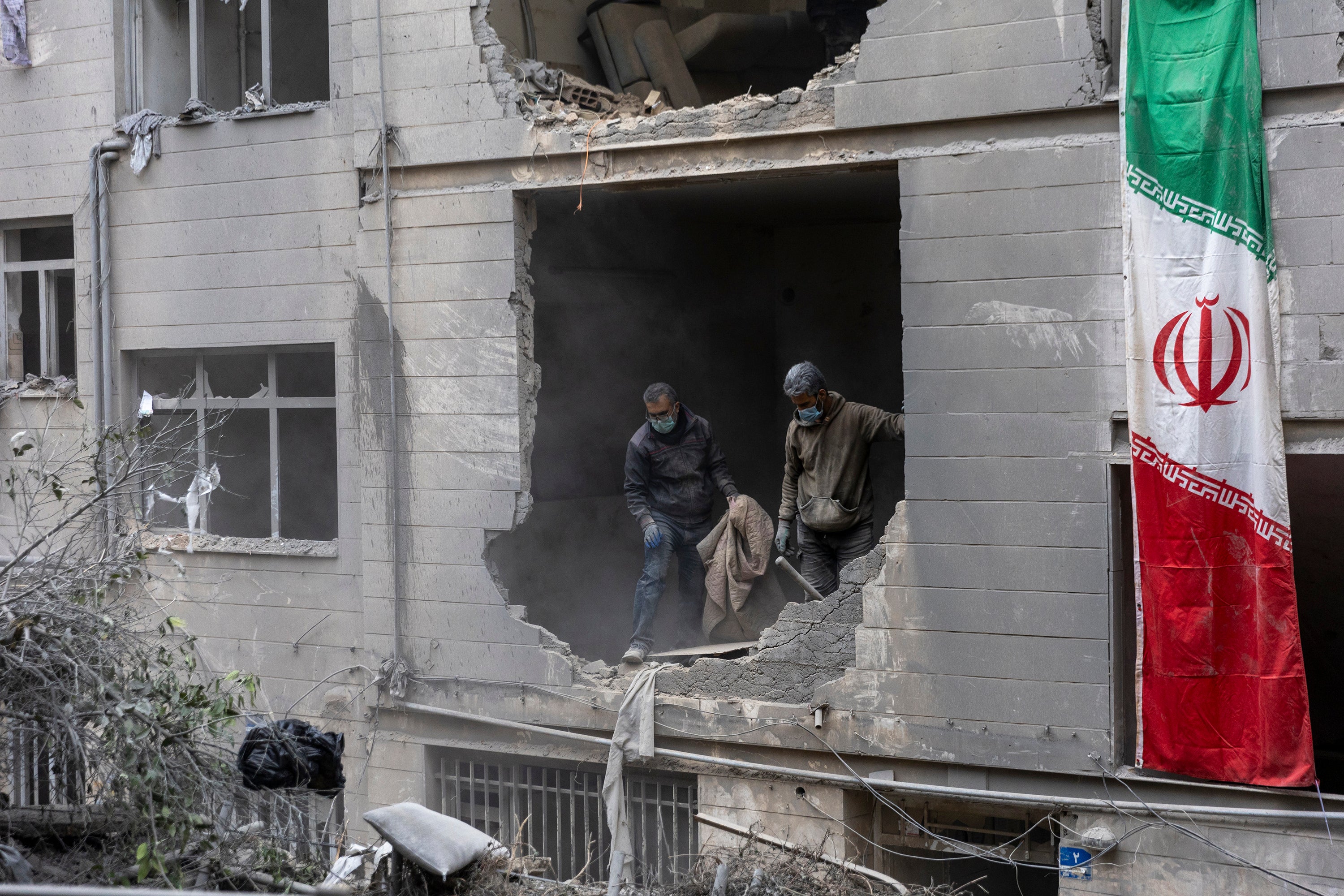 Rubble is cleared from a house in the Beryanak District after it was damaged by missile attacks last week