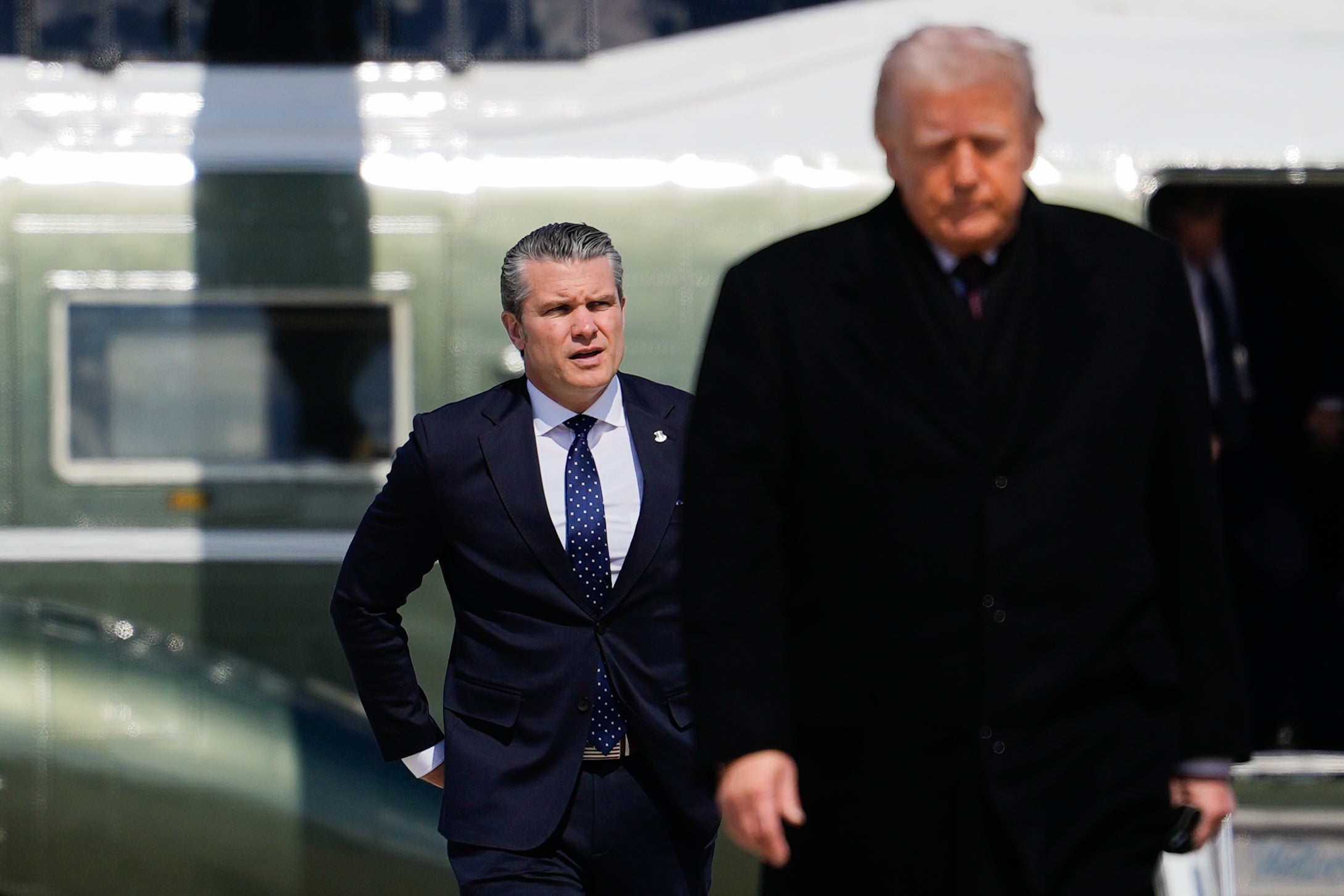 Defense Secretary Pete Hegseth follows President Donald Trump to board Air Force One Wednesday on way to dignified transfer of service members killed in Iran war