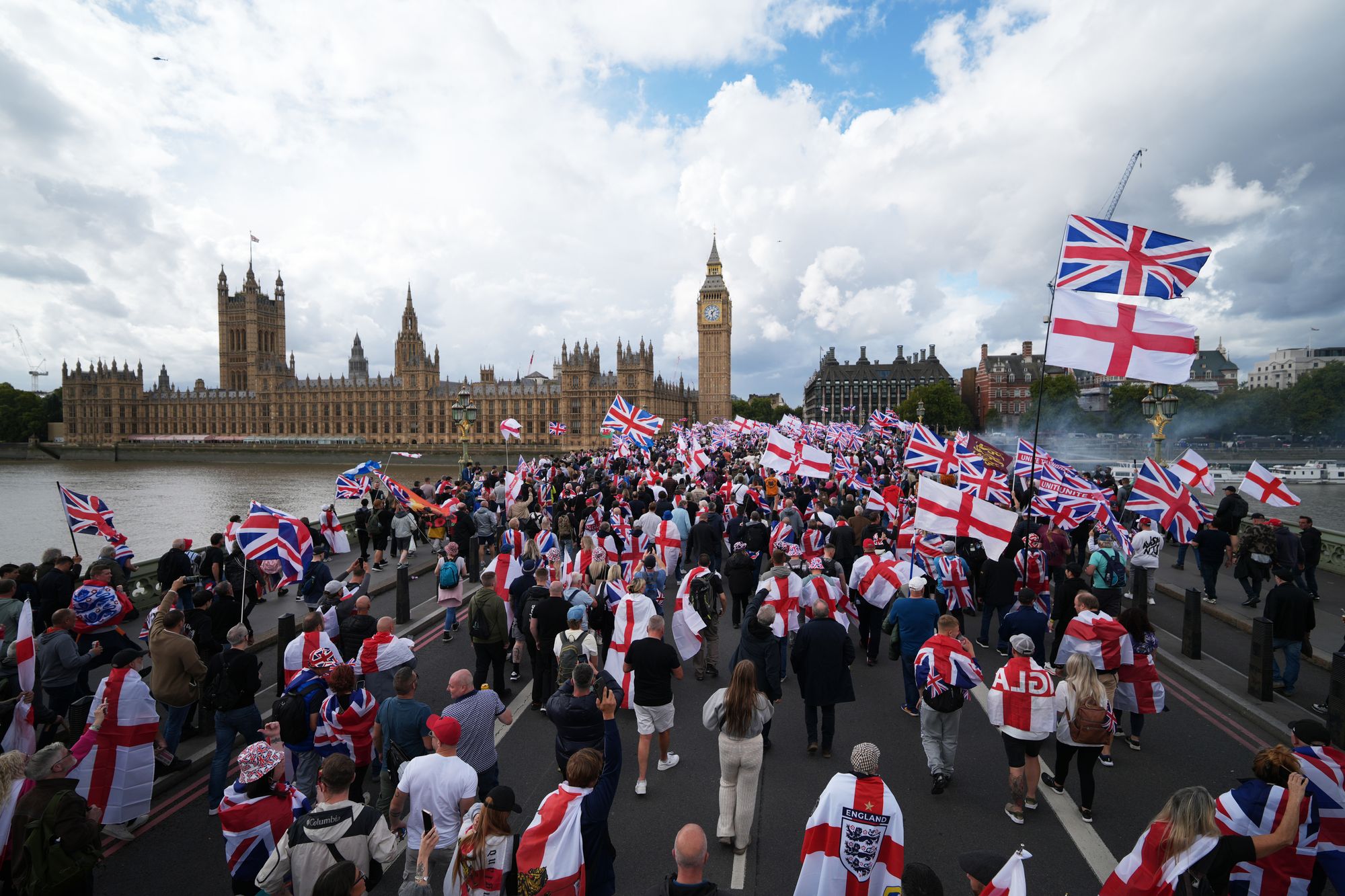 Protesters wave Union Jack and St George's England flags during the 