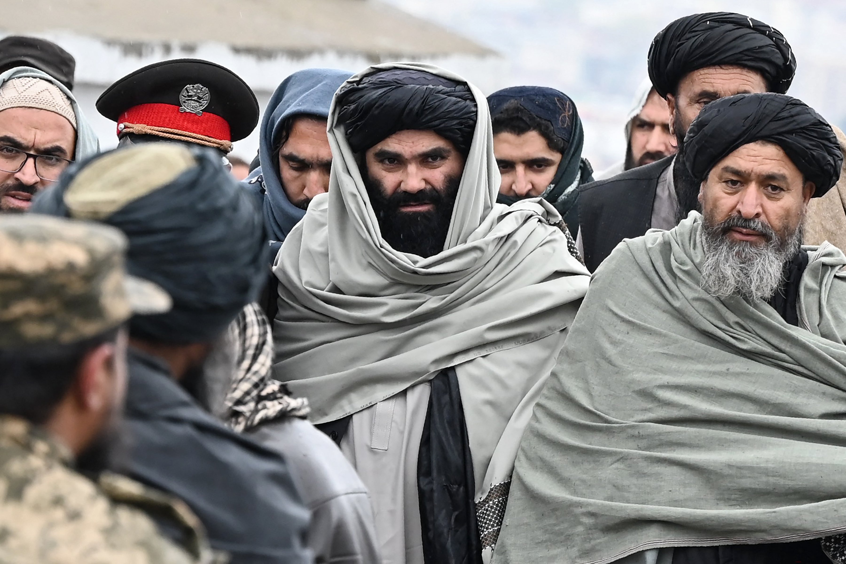 Sirajuddin Haqqani, centre, arrives to attend a mass funeral for victims of an alleged Pakistani airstrike on a drug rehabilitation centre in Kabul