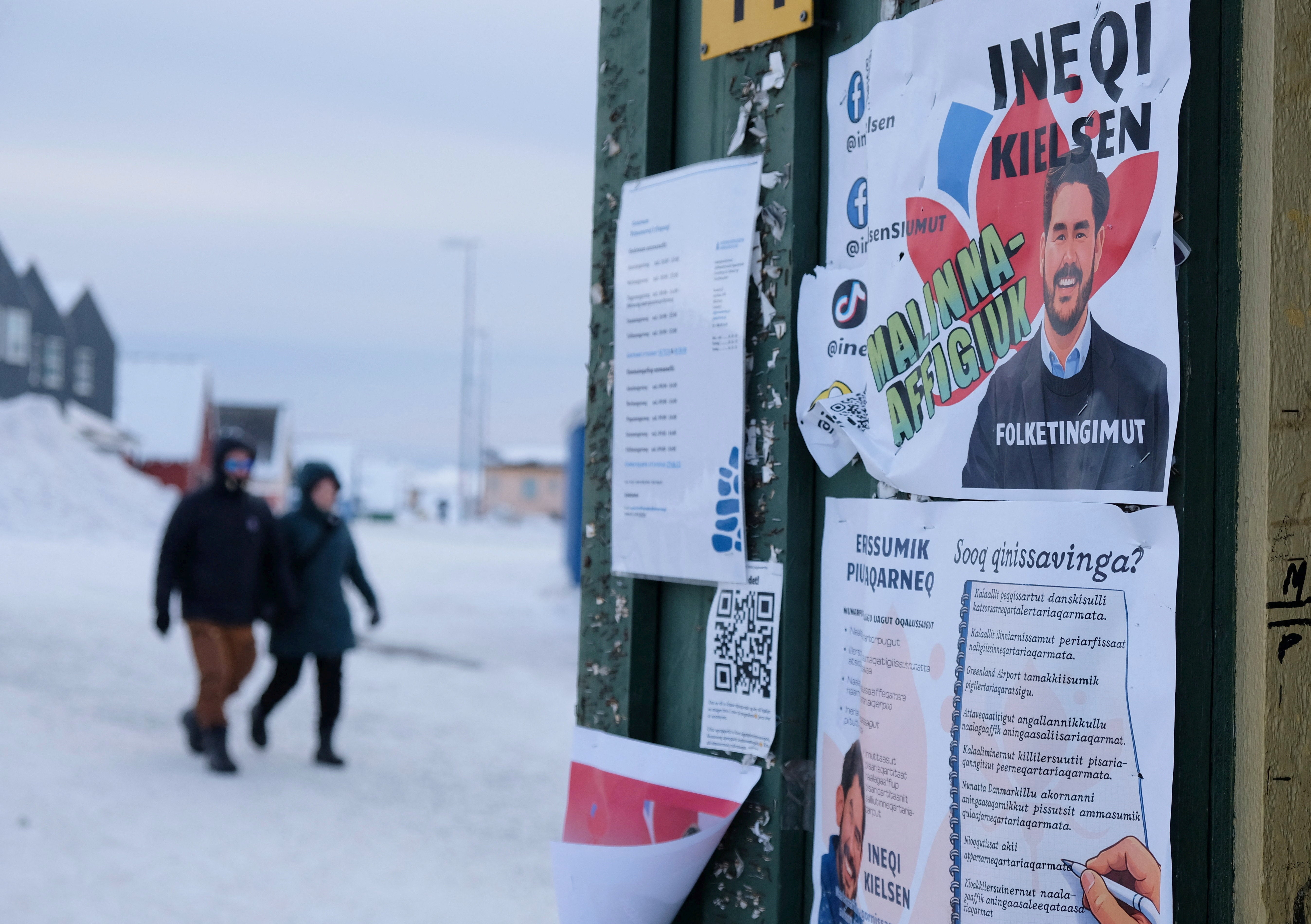 <p>People walk past posters for candidates in the upcoming Danish elections in Nuuk, Greenland</p>