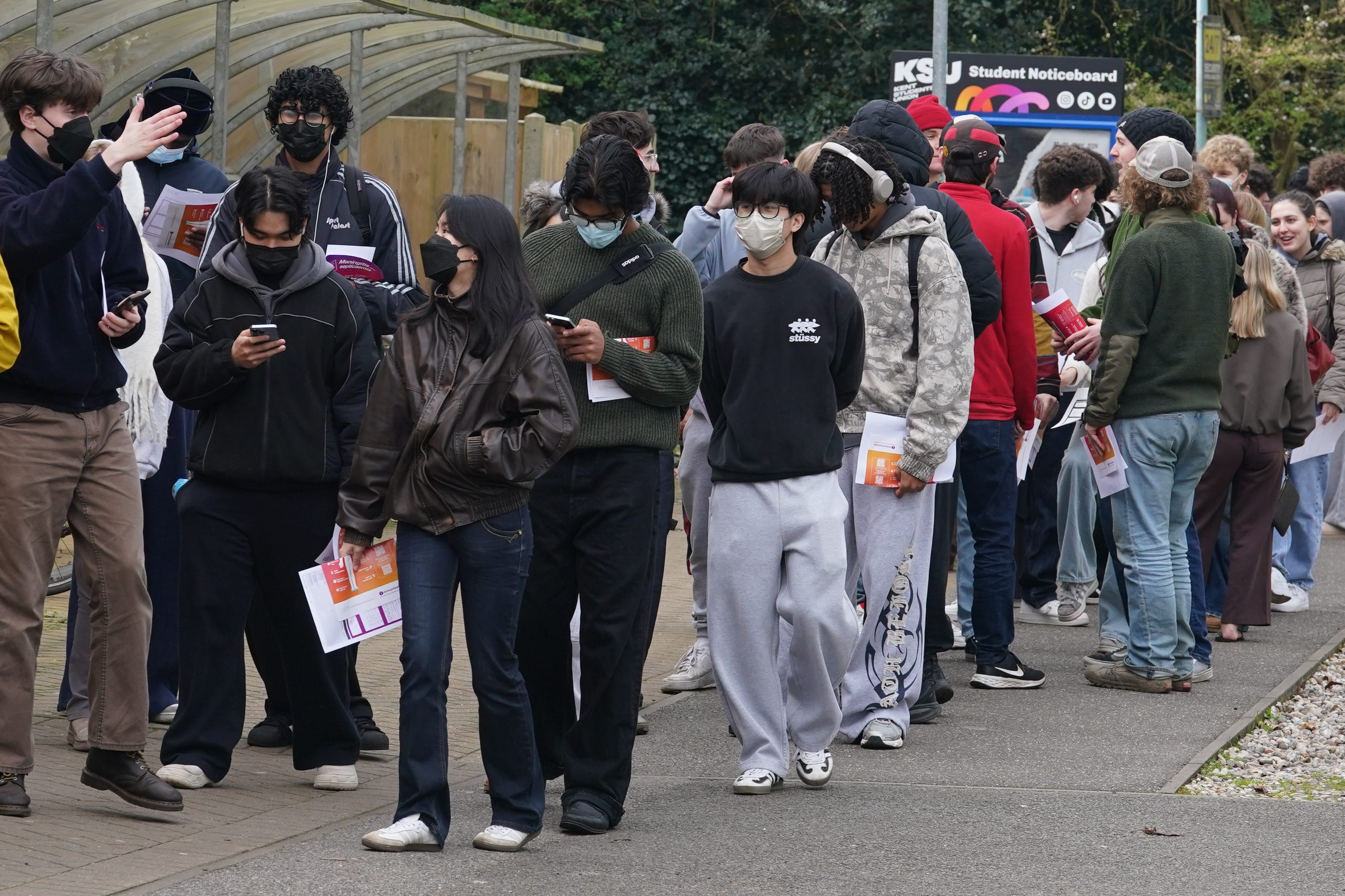 Students queuing to receive vaccines and antibiotics at the University of Kent campus in Canterbury
