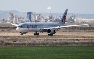 A Qatar Airways plane lands at Teruel Airport as other aircraft remain parked amid airlines withdrawing planes due to the escalating conflict in the Middle East