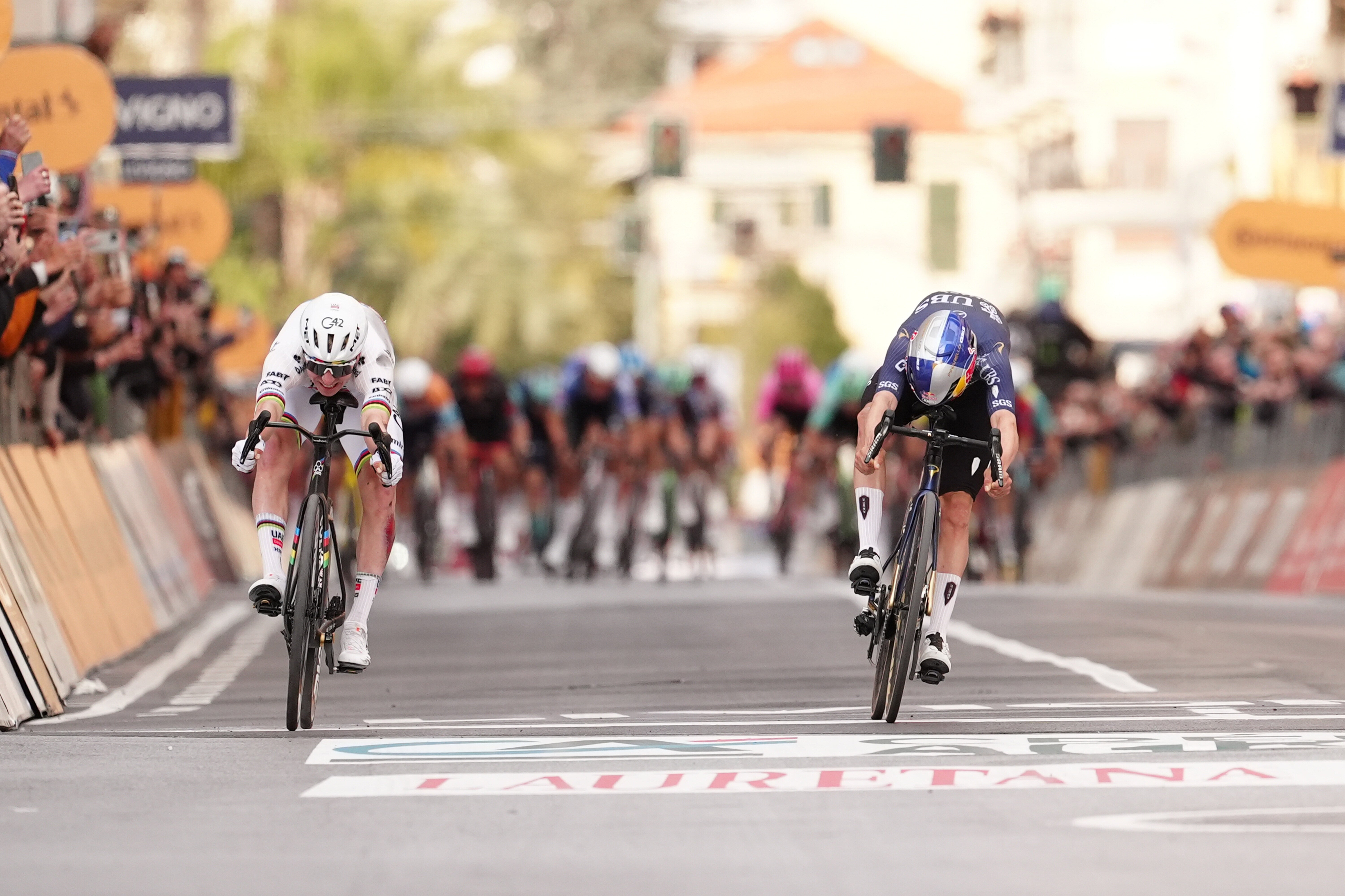 Pogacar crosses the finish line ahead of Pidcock