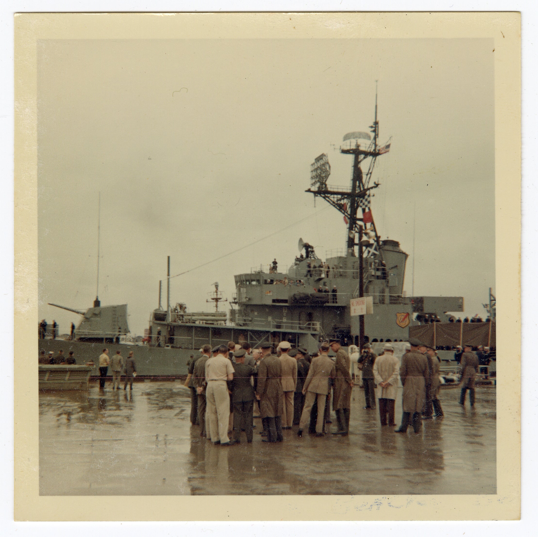 A crowd of military personnel gathering as astronauts Neil Armstrong and David Scott look out from a ship at Naha Air Base in Okinawa, Japan, in 1966