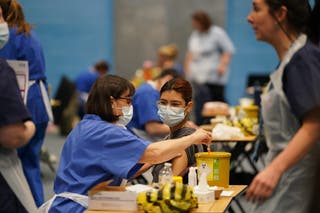 A student receiving an injection in the sports hall at the University of Kent campus in Canterbury