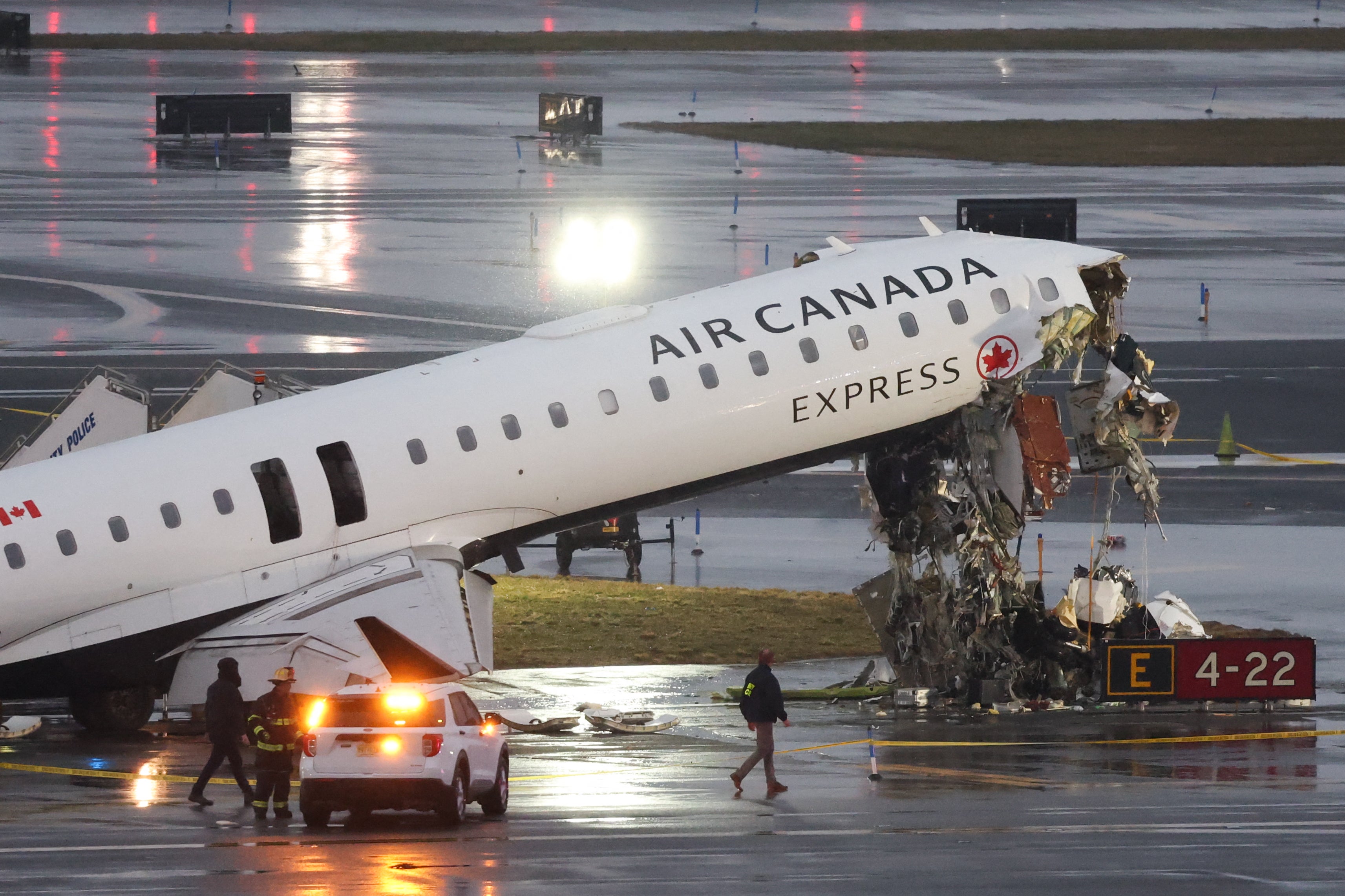 The wrecked CRJ-900 sits on the runway at LaGuardia Airport in New York