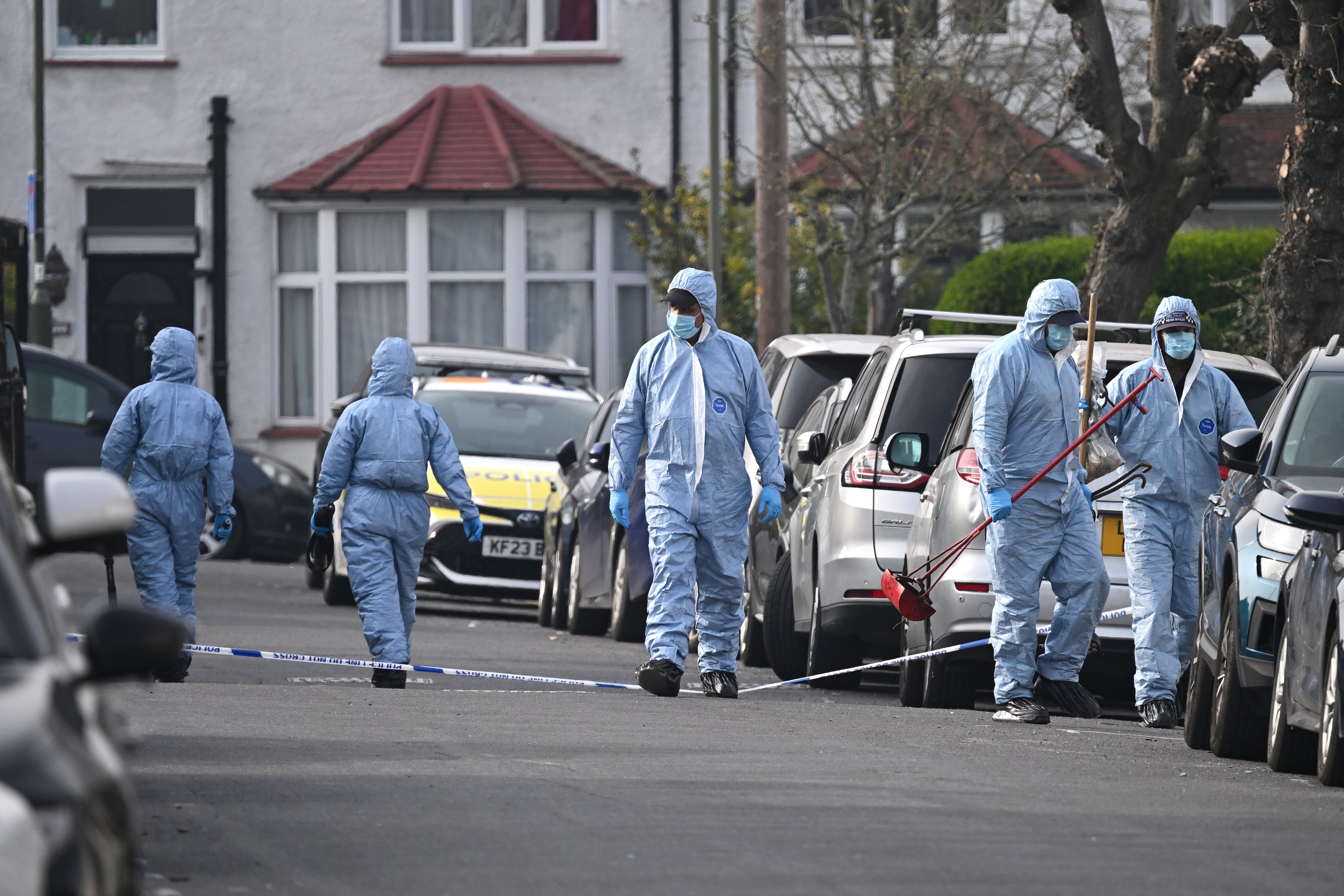 A Met forensic team investigate a location near to where four Hatzola ambulances were set on fire