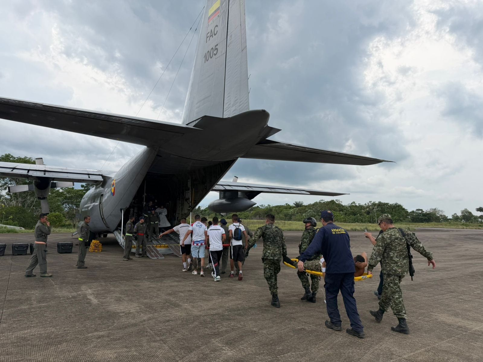 In this photo distributed by Colombia's Armed Forces press office, people who were injured on a military cargo plane that crashed shortly after take off are loaded on to another military plane to evacuate them for treatment, from Puerto Leguizamo, Colombia, Monday, 23 March 2026