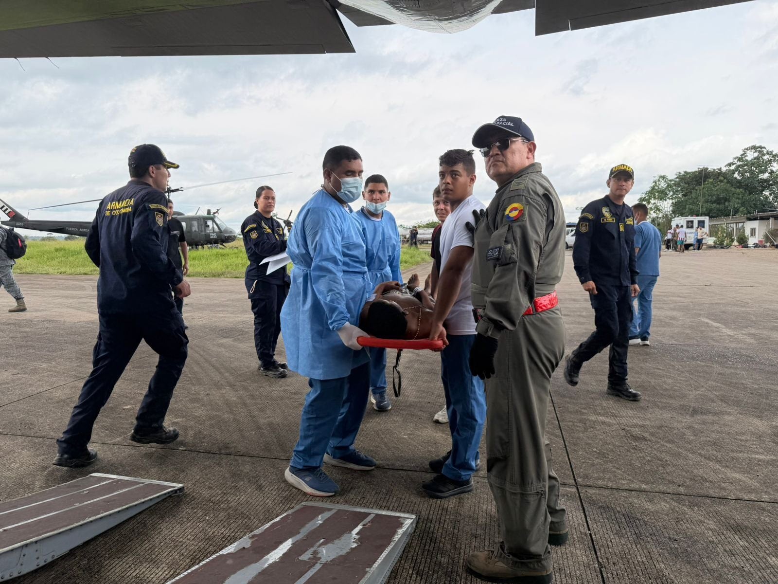 In this photo distributed by Colombia's Armed Forces press office, people who were injured on a military cargo plane that crashed shortly after take off are loaded on to another military plane to evacuate them for treatment, from Puerto Leguizamo, Colombia, Monday, 23 March 2026