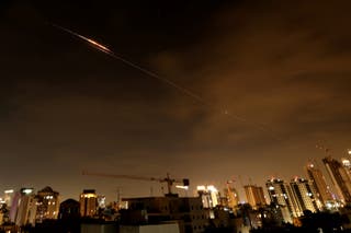 Rocket trails are seen in the sky amid a fresh barrage of Iranian missile attacks above the Israeli coastal city of Netanya