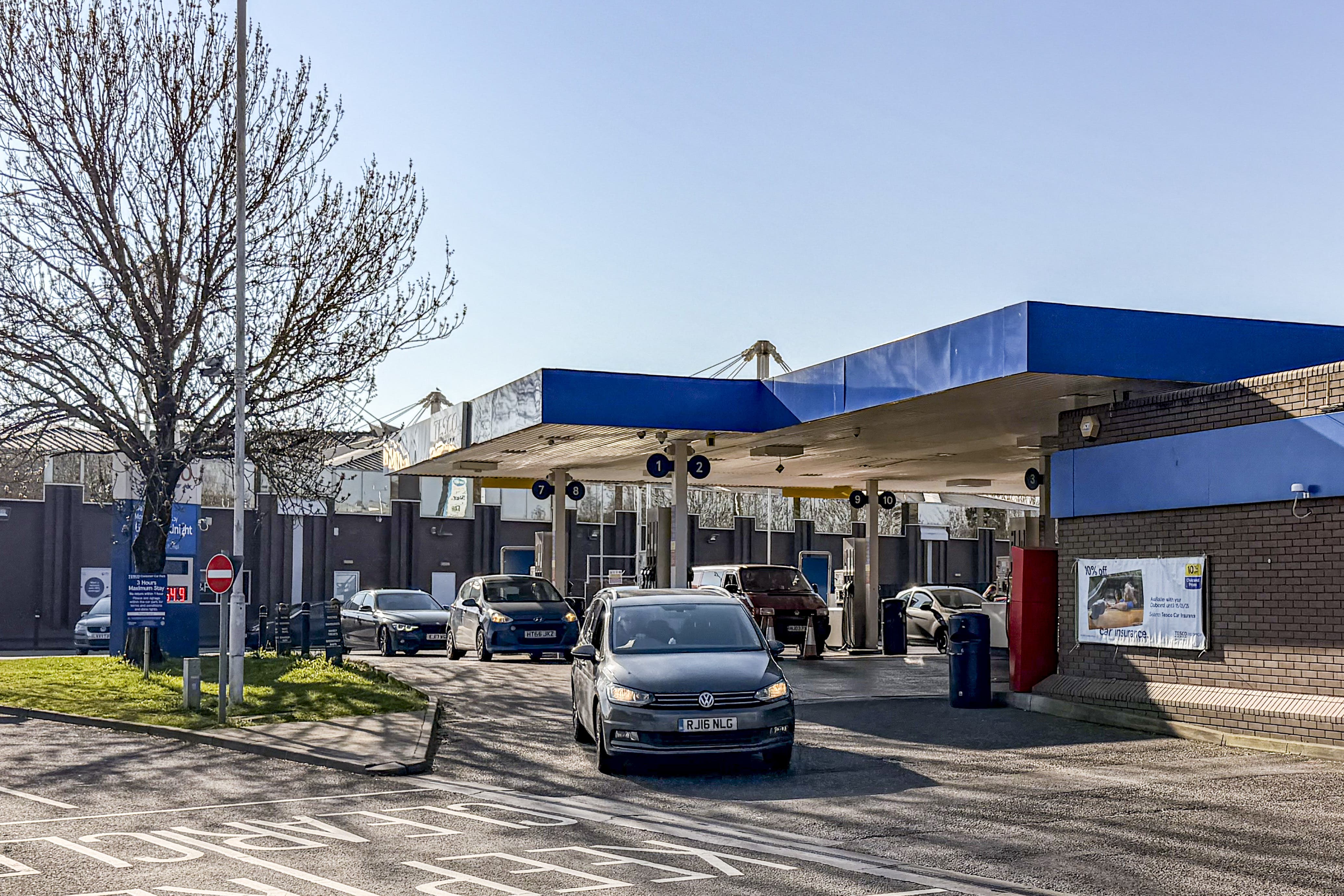 Vehicles queue to fill up at a petrol station in Bristol