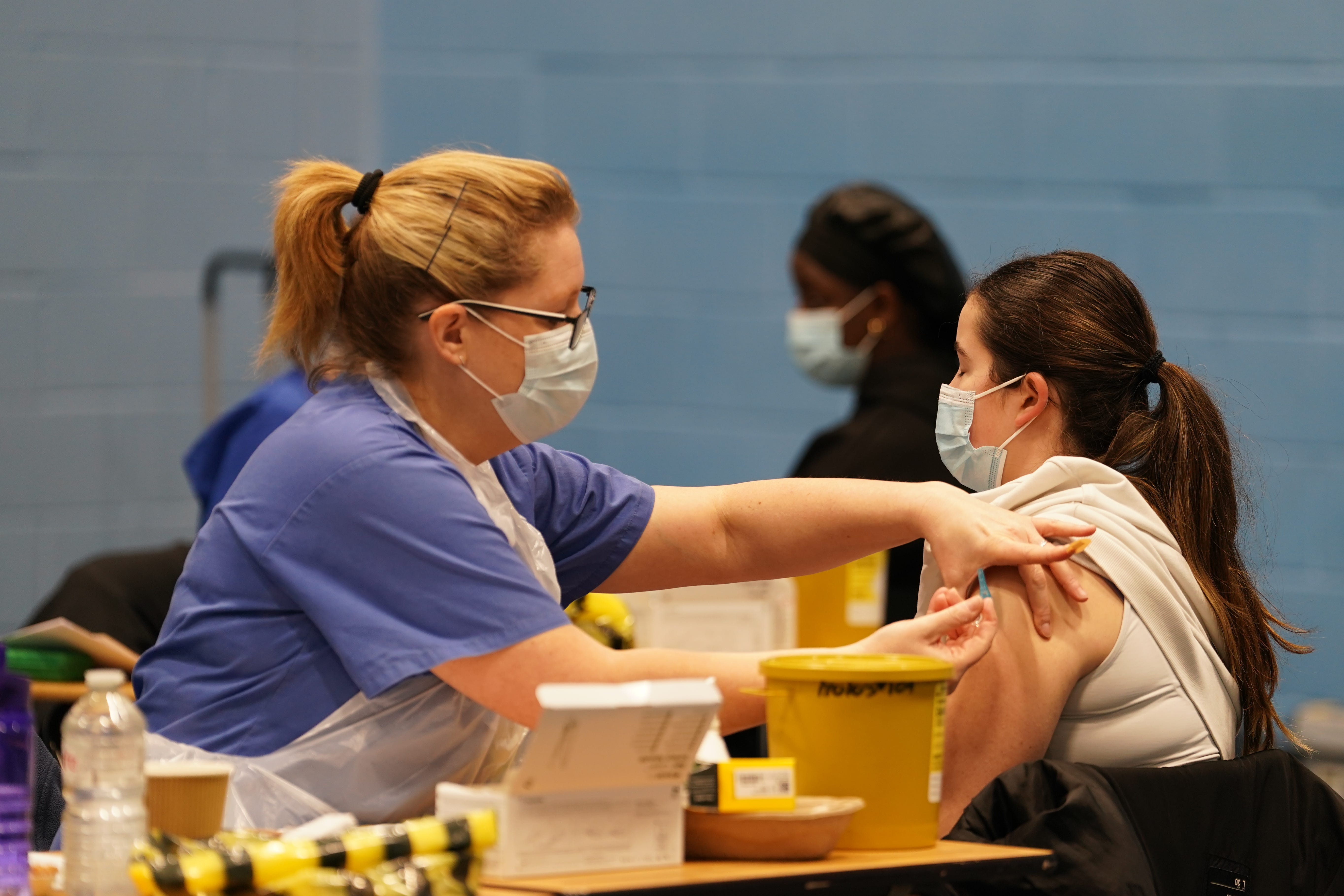 A student receiving an injection in the sports hall at the University of Kent campus in Canterbury