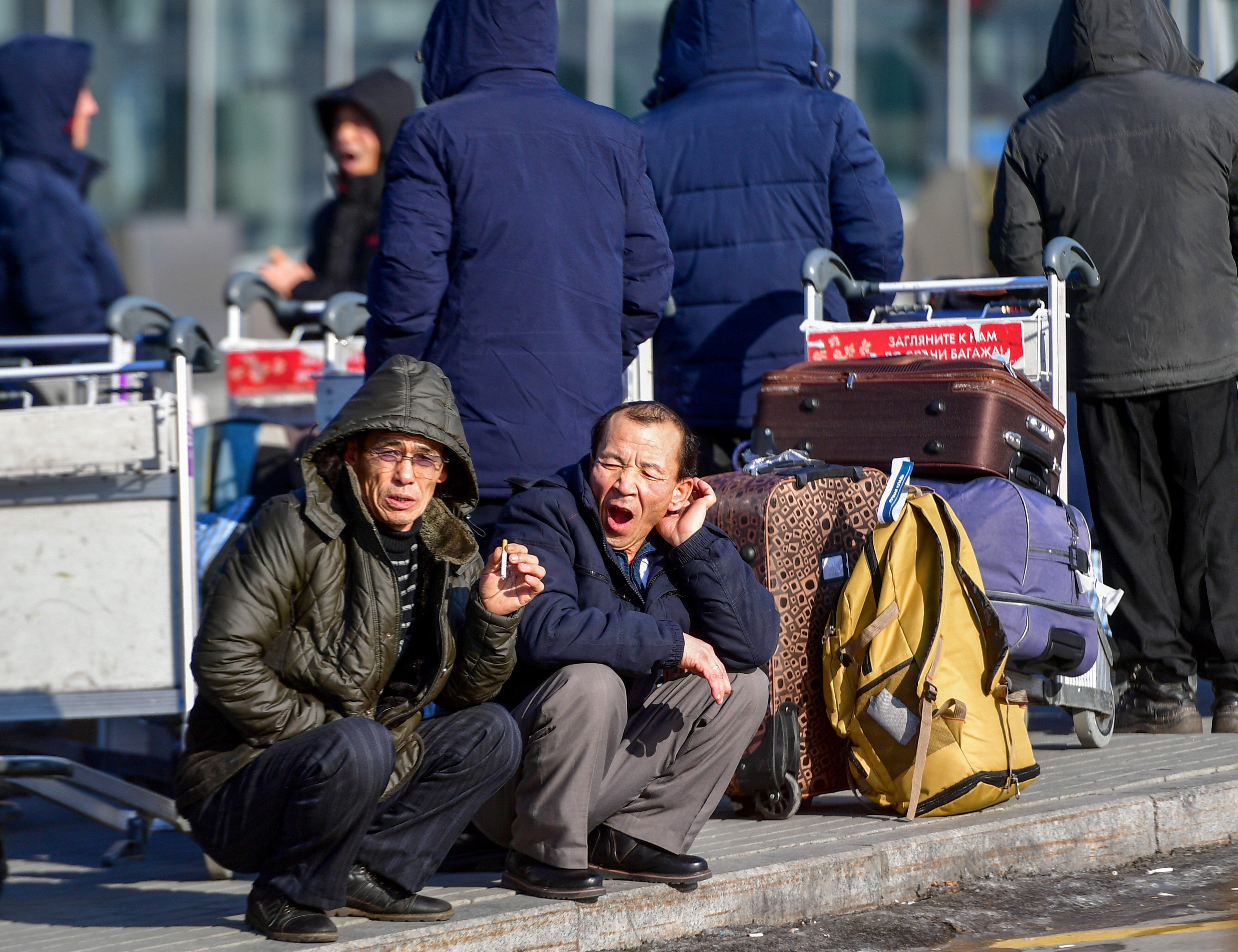 File: North Korean workers wait for their flight at the airport of Vladivostok