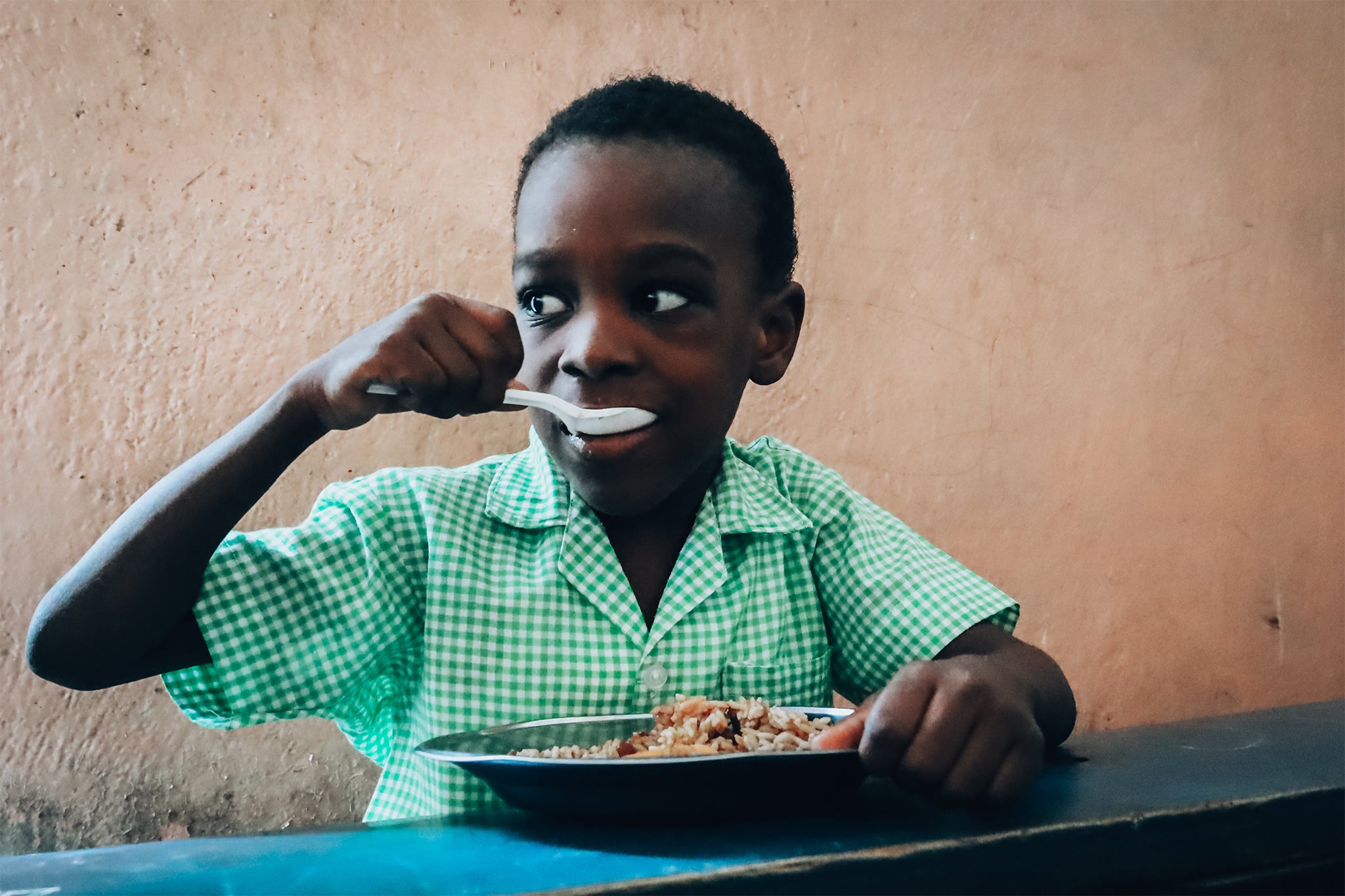 A child eating Mary's Meals at school in Port-au-Prince