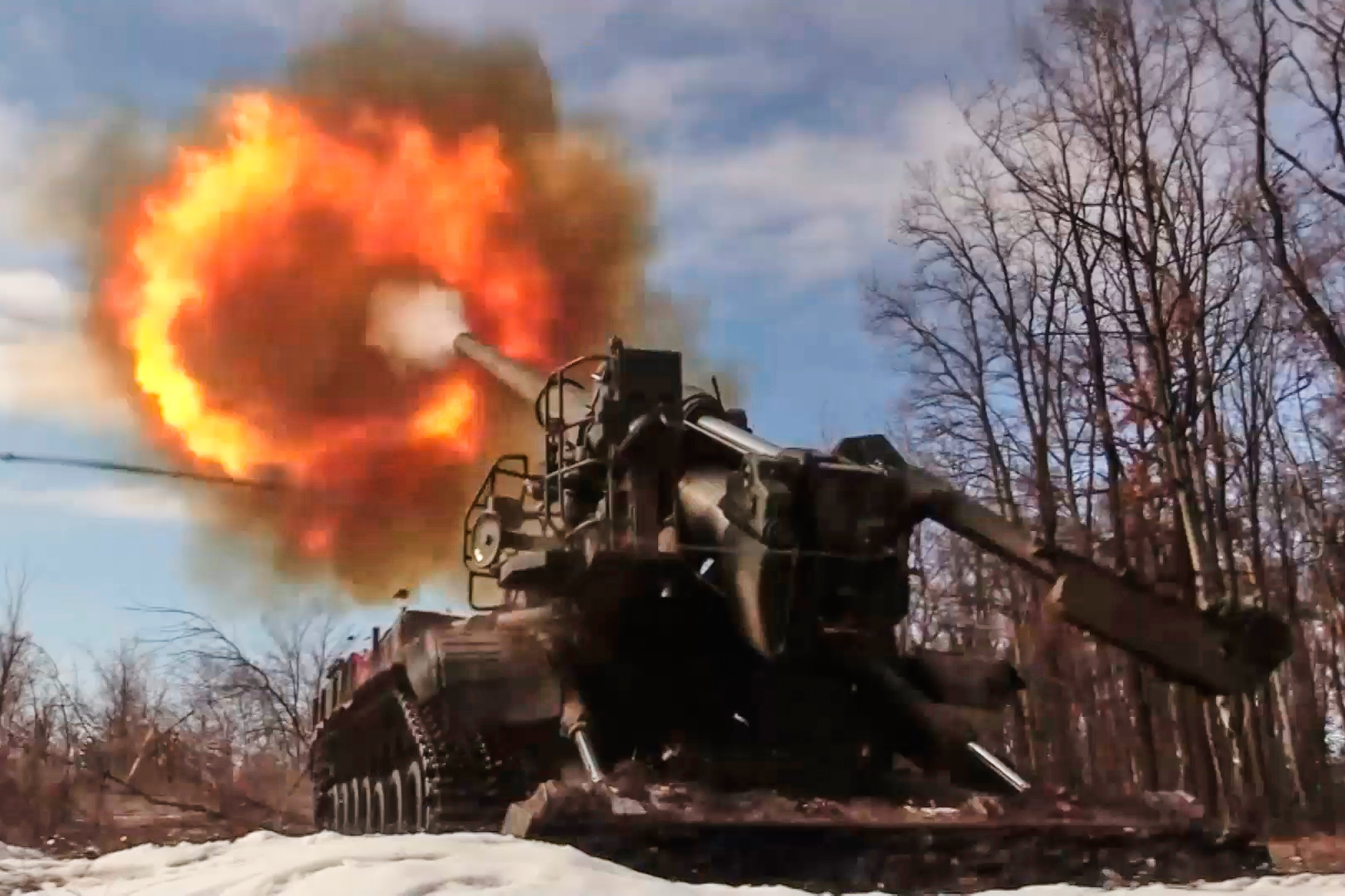 A Russian Pion self-propelled 203 mm cannon fires towards a Ukrainian position