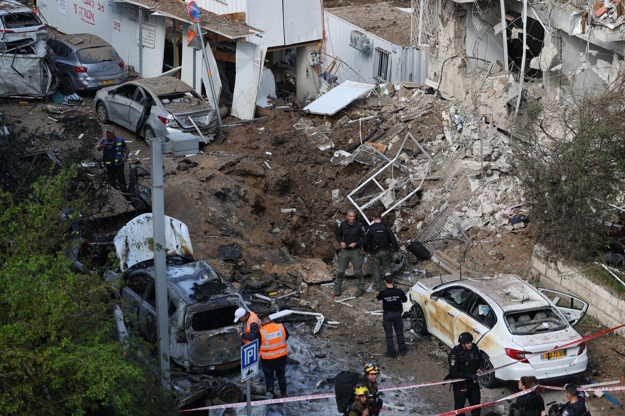 Israeli emergency service personnel gather at the site of an Iranian missile strike in Tel Aviv on March 24