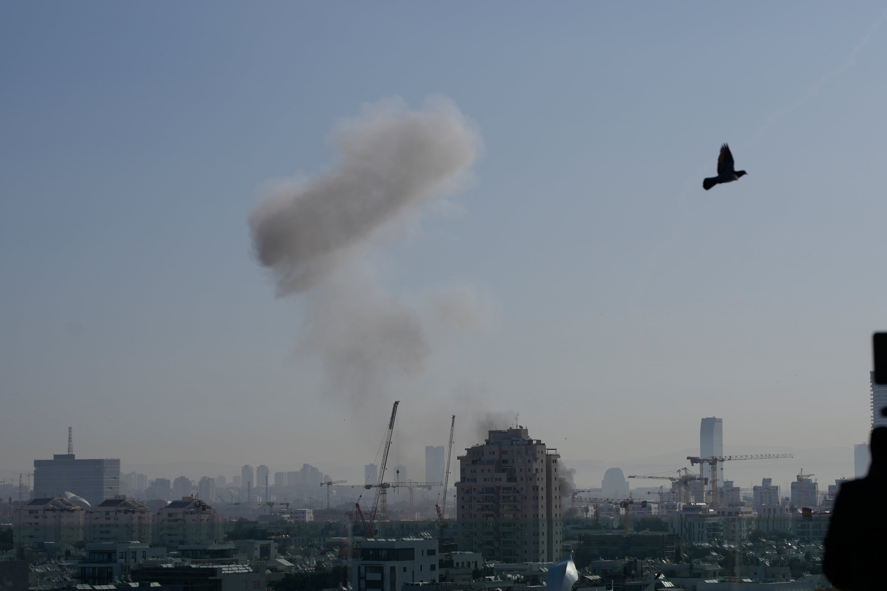Smoke billows following an Iranian missile strike in Tel Aviv on Tuesday