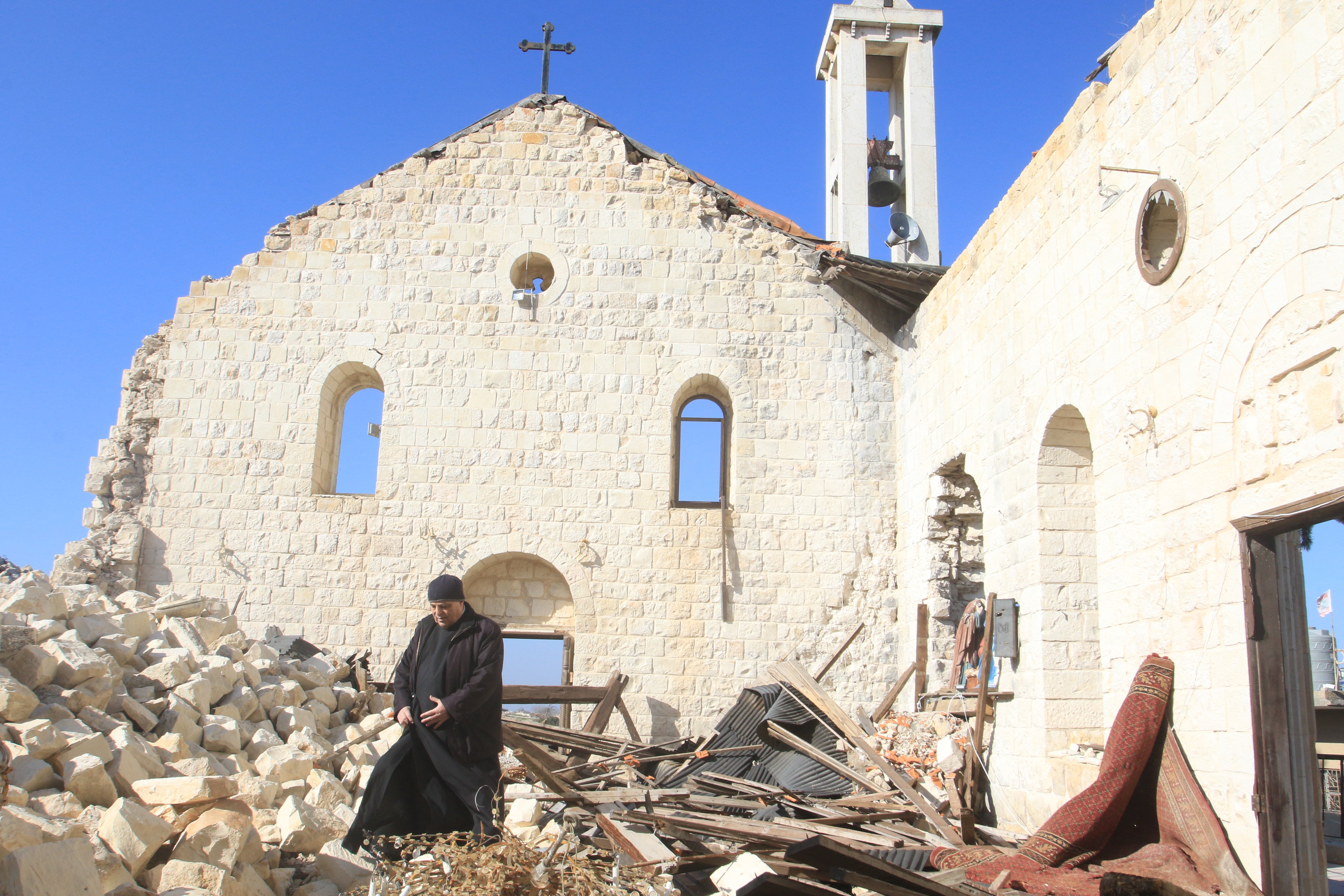 A worshipper walks inside the badly damaged St. George's Church, following a Christmas mass in the southern Lebanese village of Yaroun near the border with Israel last Christmas