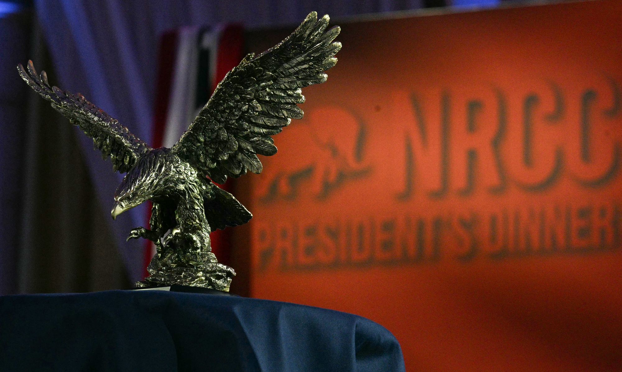 The America First Award, represented by an eagle statue, is displayed on the side of the stage ahead of its presentation to Trump at the Republican fundraiser