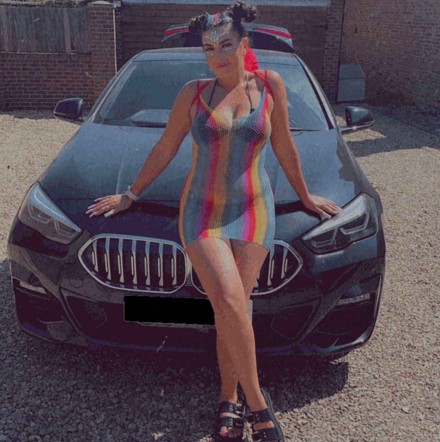 Catherine Wieland leaning on the bonnet of her PIP Motability car before attending a festival.