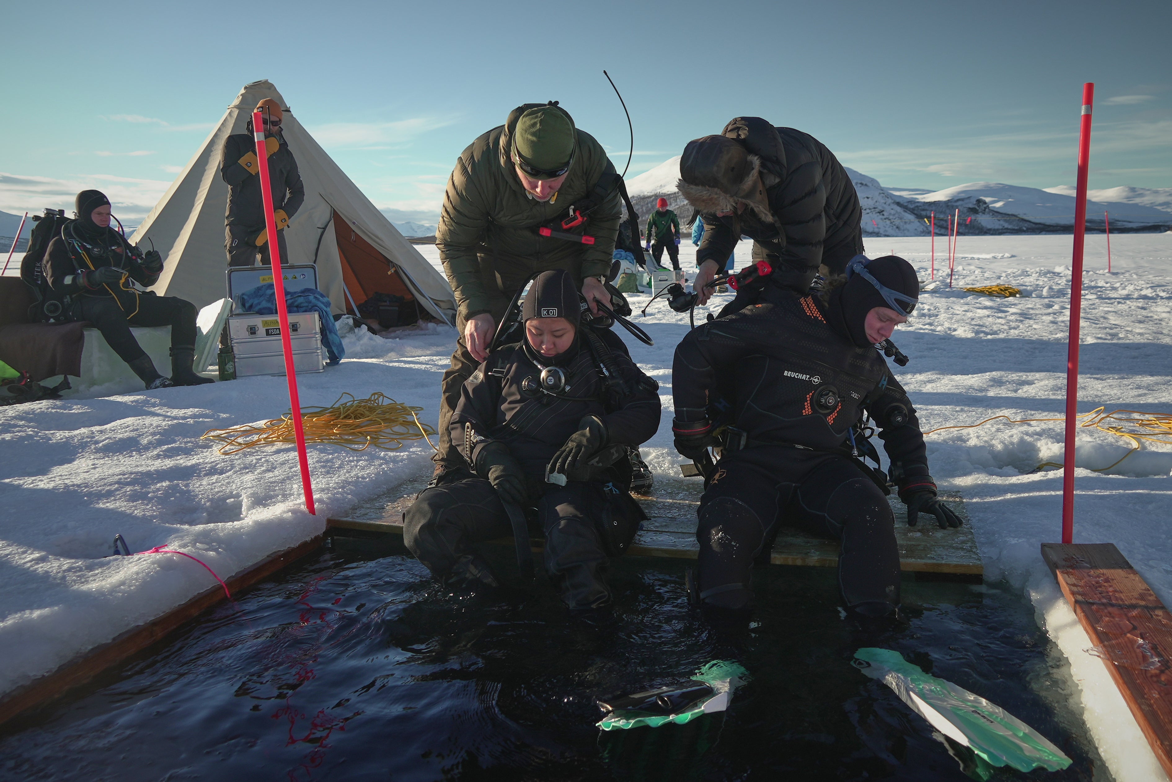 Ruari Buijs, a marine biology and oceanography student, right, and Caroline Chen, a scientific diver and research assistant, prepare to dive during a Polar Scientific Diving class in Kilpisjärvi
