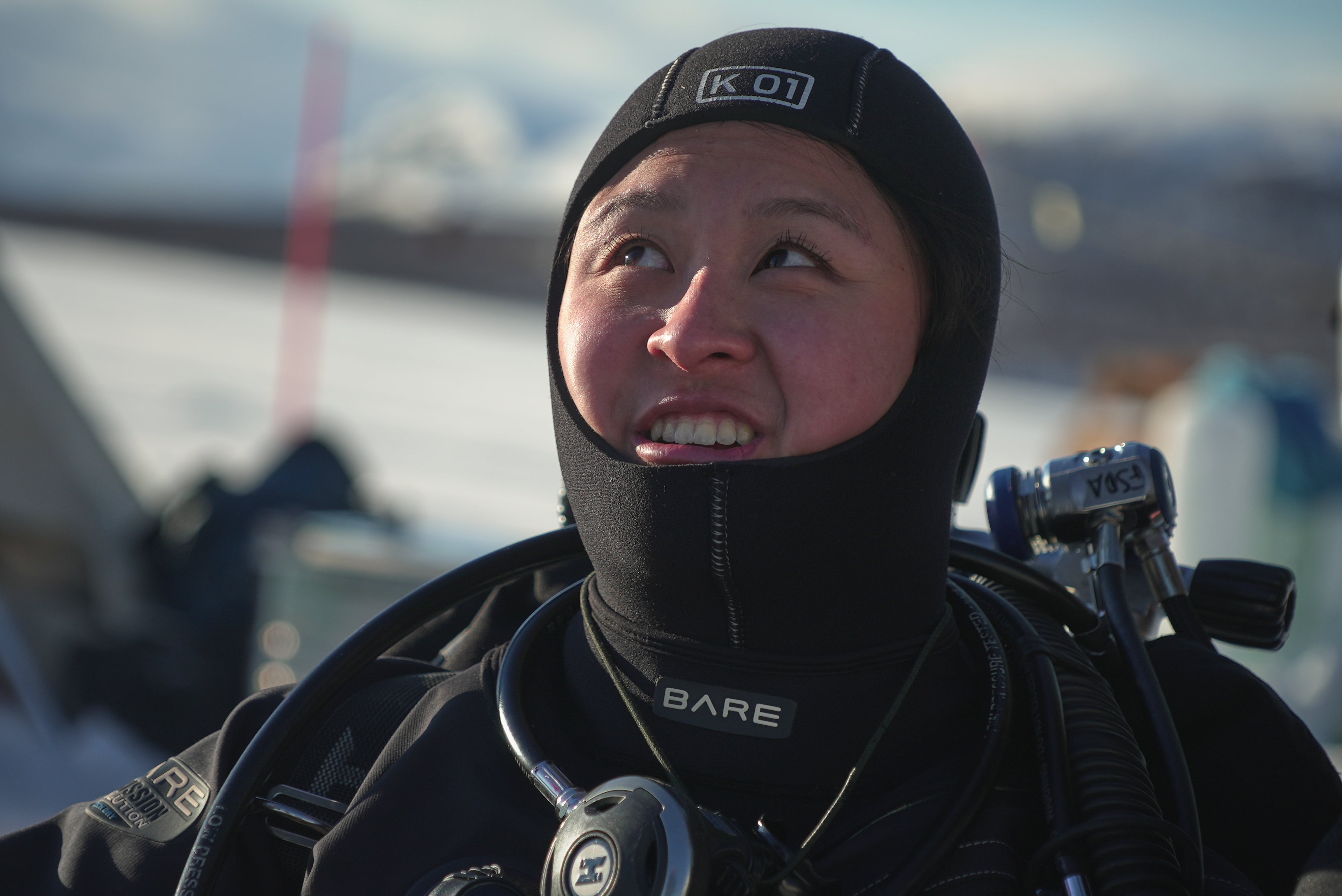Caroline Chen, a scientific diver and research assistant, smiles before diving during a Polar Scientific Diving class in Kilpisjärvi, Finland,