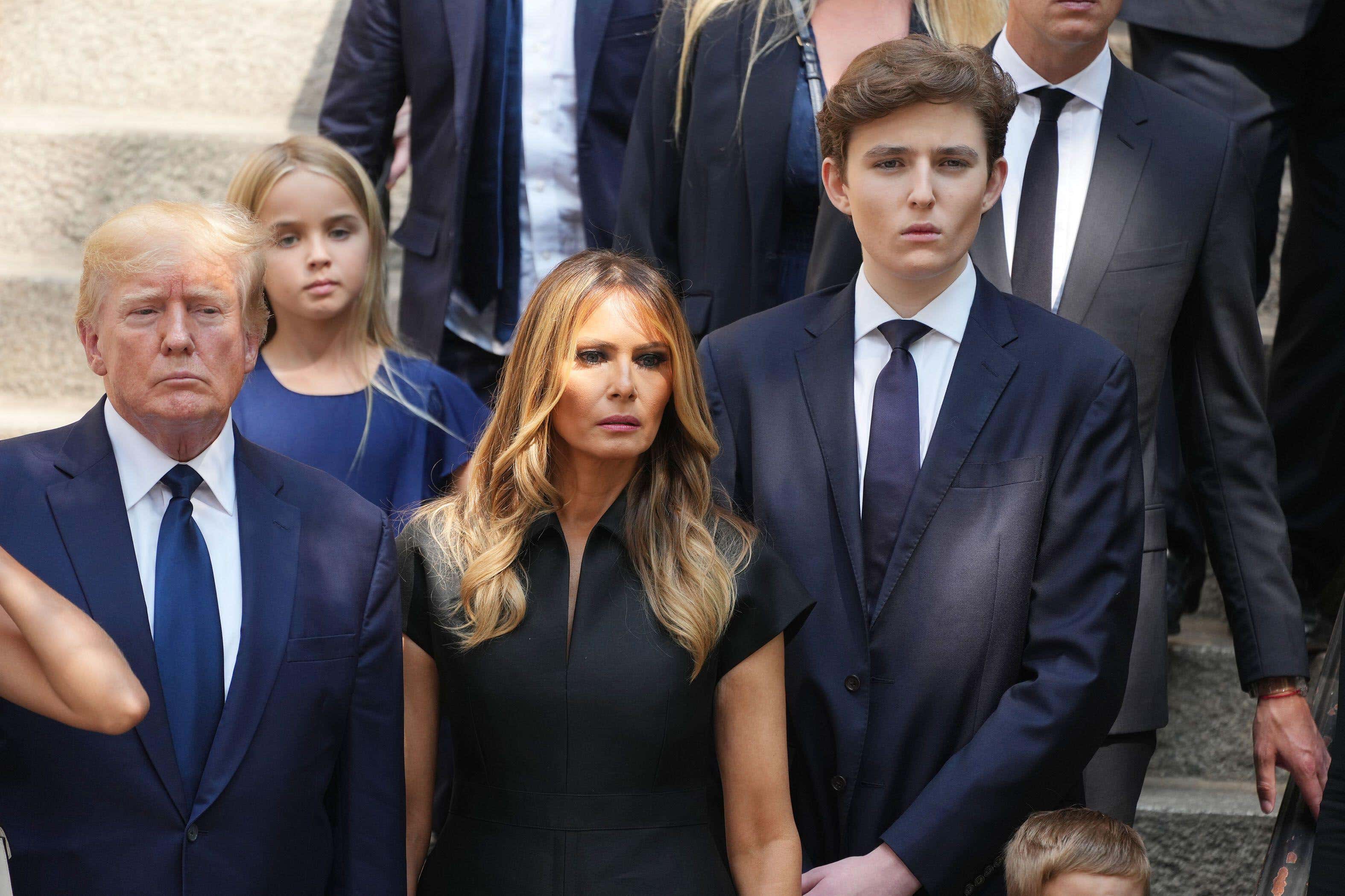 Barron Trump, right, with parents Donald and Melania Trump