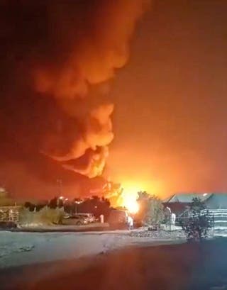 Smoke rises from an explosion in the direction of Ali Al Salem Air Base, amid the U.S.-Israeli conflict with Iran, in Al Jahra on 27 March.
