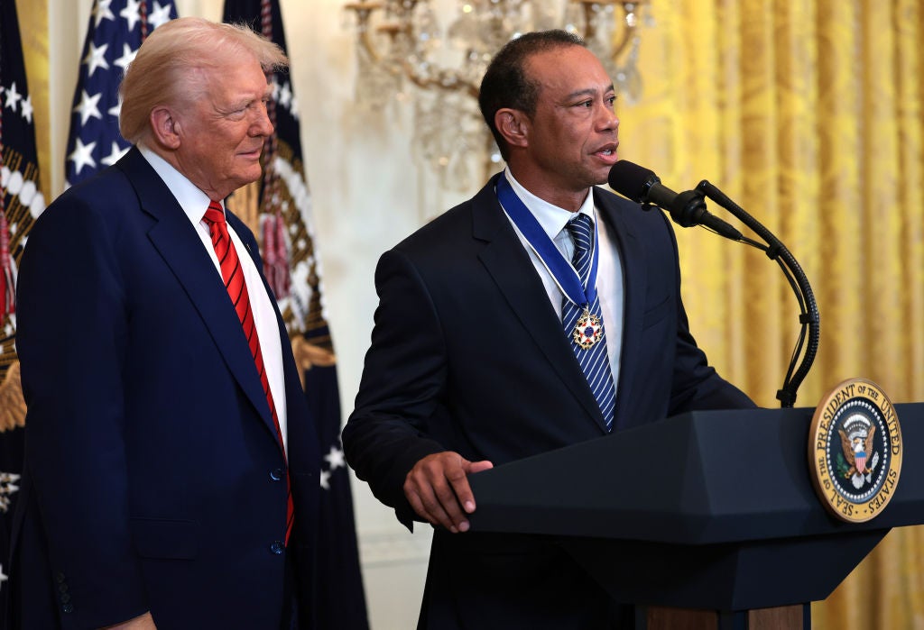 Tiger Woods (right) alongside Donald Trump at the White House