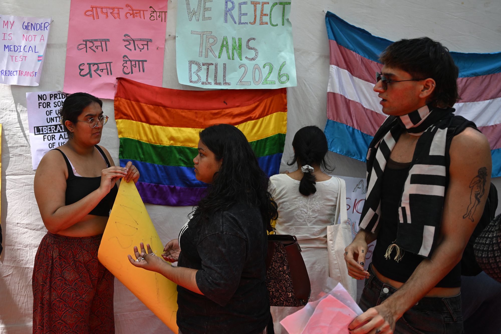 Supporters and members of the transgender community prepare placards during a protest in New Delhi