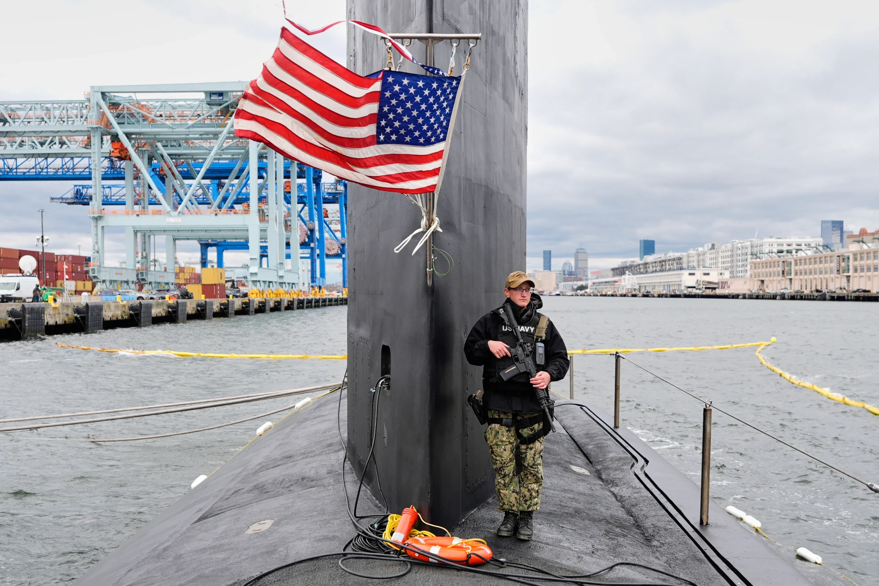 A sailor stands guard next to the sail of the USS Massachusetts, the Navy’s newest nuclear-powered attack submarine, Friday, March 27, 2026, in Boston. (AP Photo/Robert F. Bukaty)