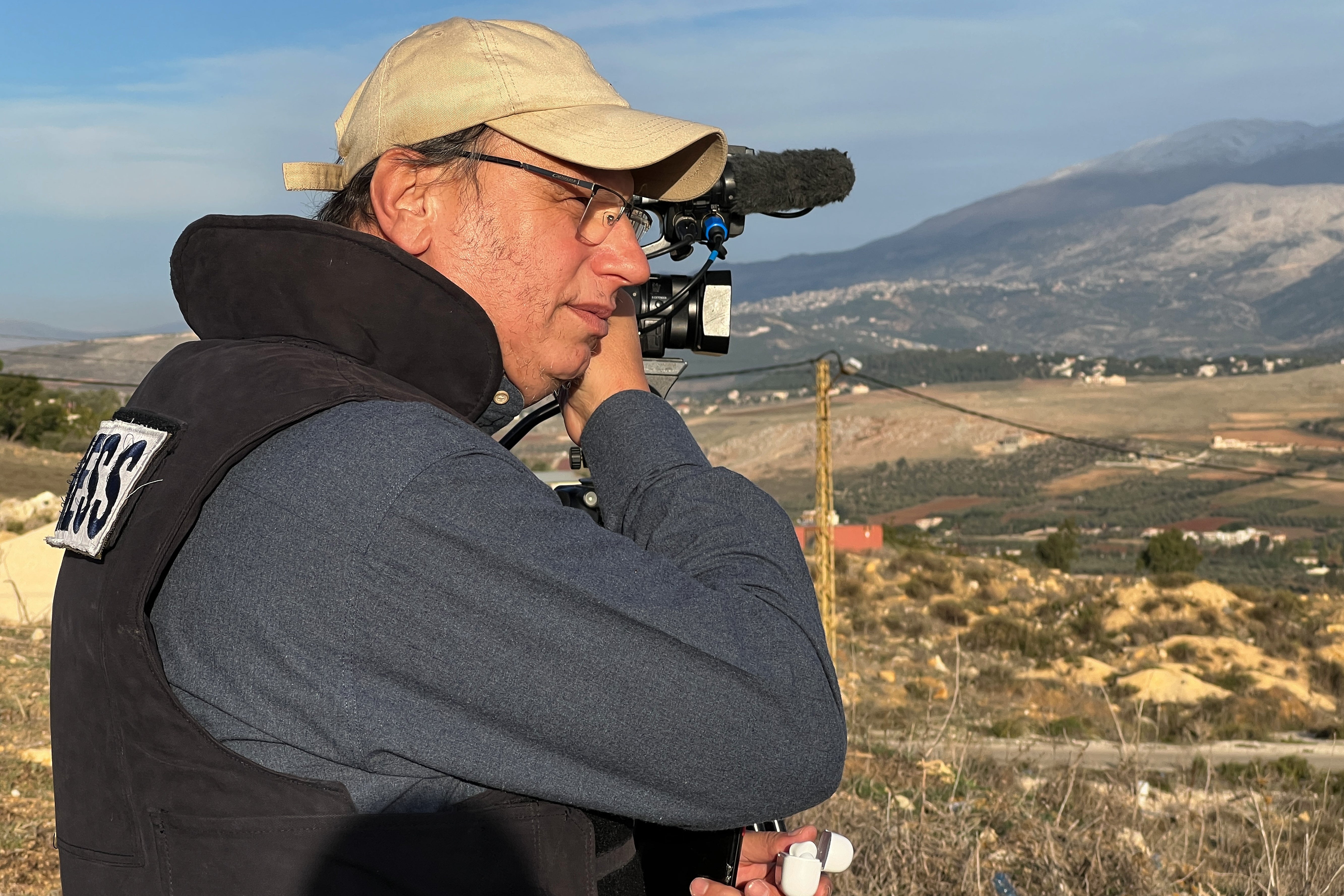 Hezbollah's al-Manar TV correspondent Ali Shoeib, who was killed in an Israeli strike in Jezzine with other journalists on Saturday, March 28, 2026, speaks on his mobile phone in Marjayoun town, Wednesday, Nov. 22, 2024. (AP Photo/Hussein Malla)