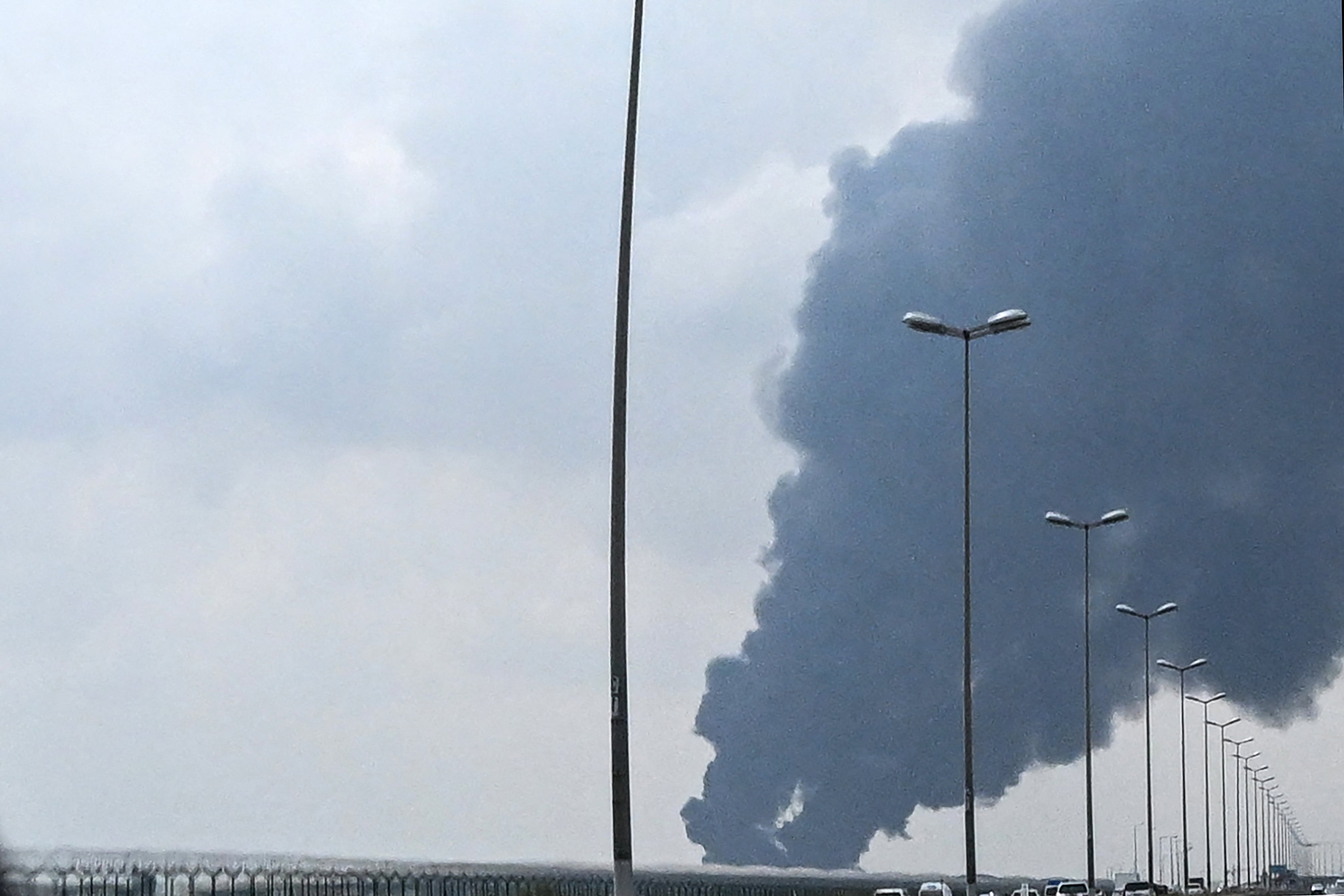 Smoke rises from the area of the Kuwait International Airport after a reported drone strike hit a fuel depot on March 25, 2026