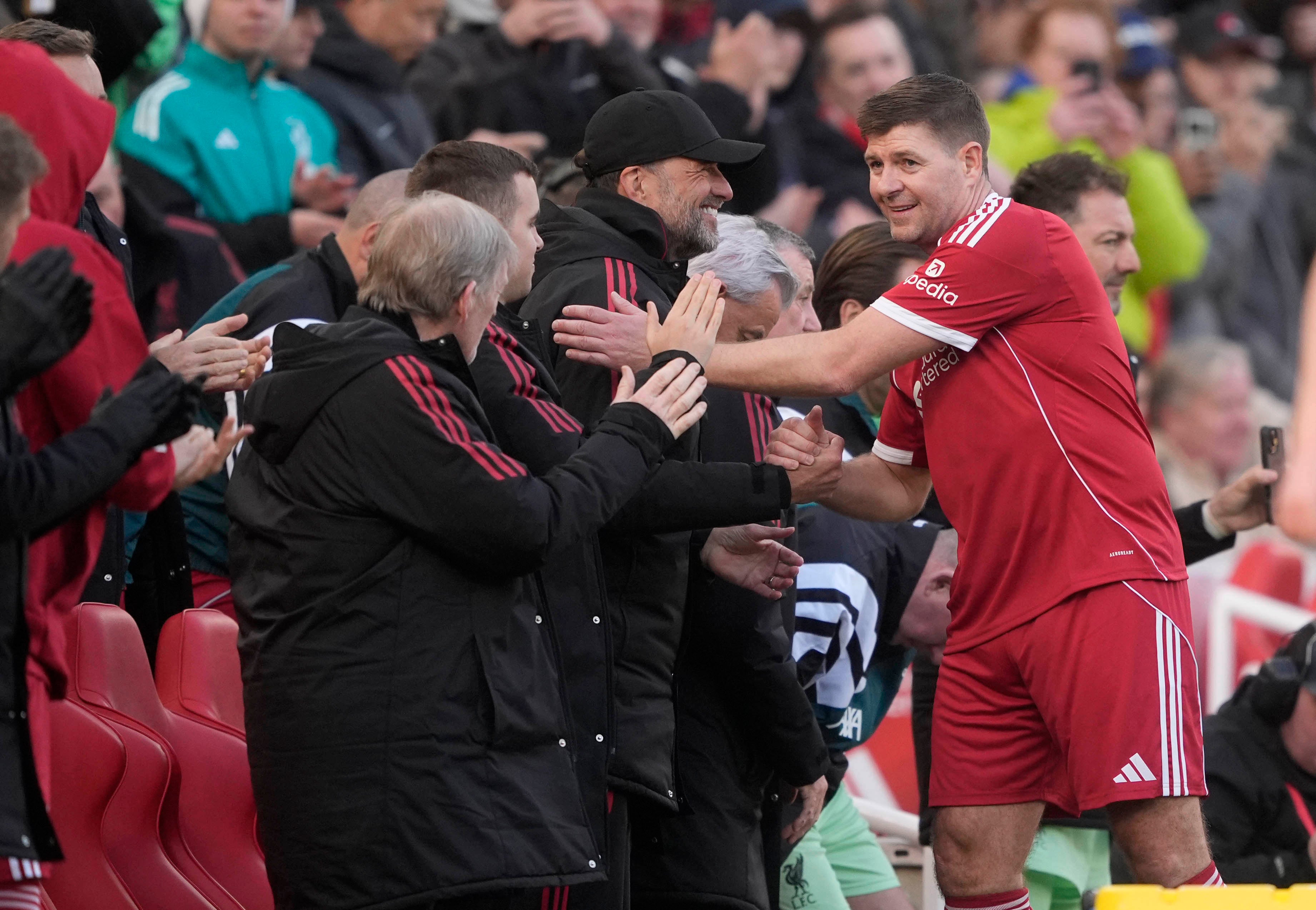Steven Gerrard shakes hands with Jurgen Klopp after being substituted during the Legends match