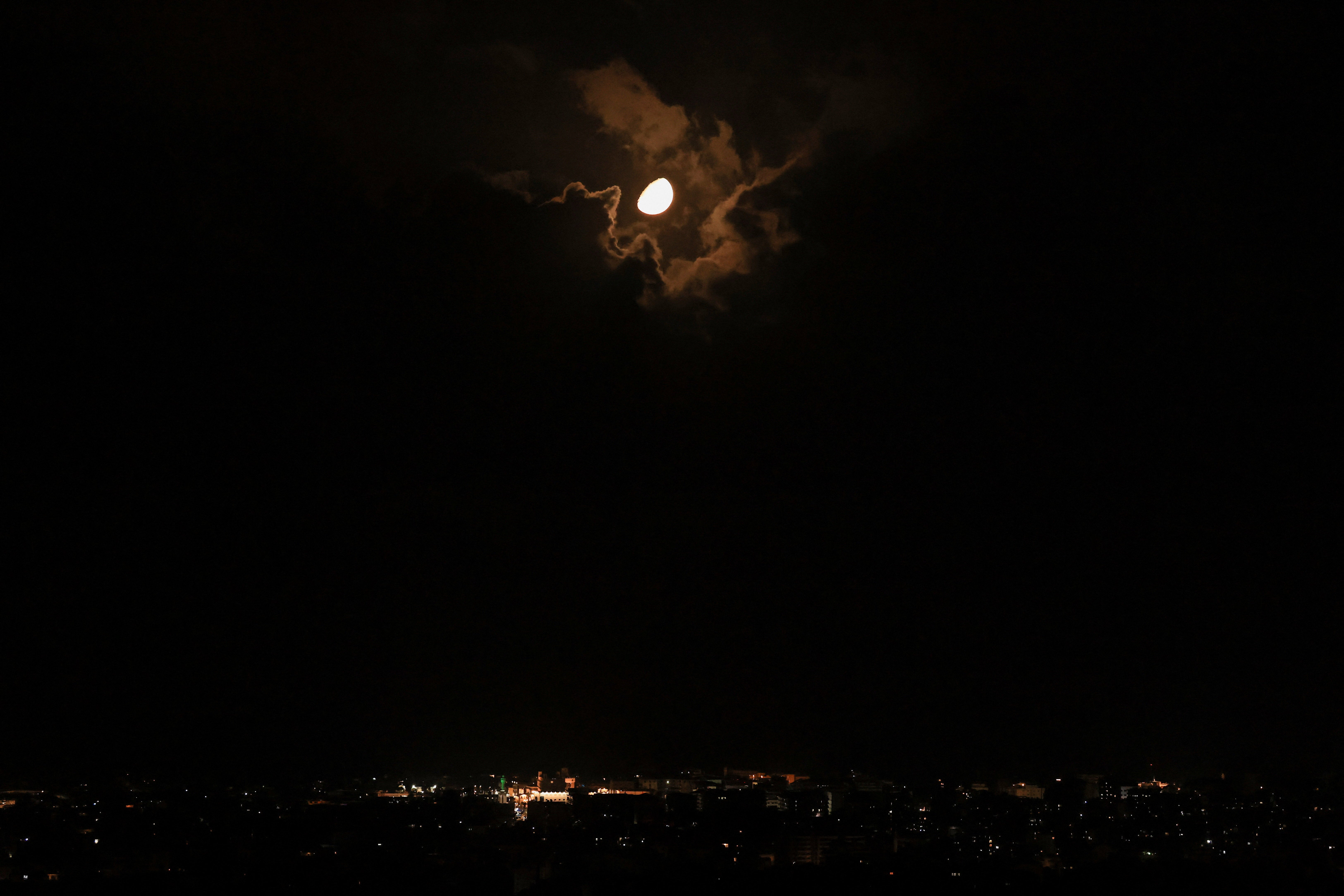 The moon illuminates the sky above Beirut's southern suburbs, amid escalating hostilities between Israel and Hezbollah, as the US-Israeli conflict with Iran continues, in Lebanon